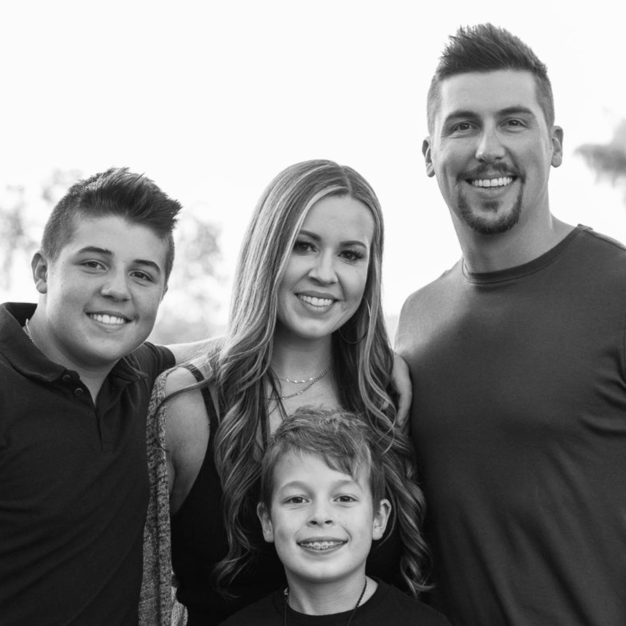 Black and white photo of a family of four outdoors