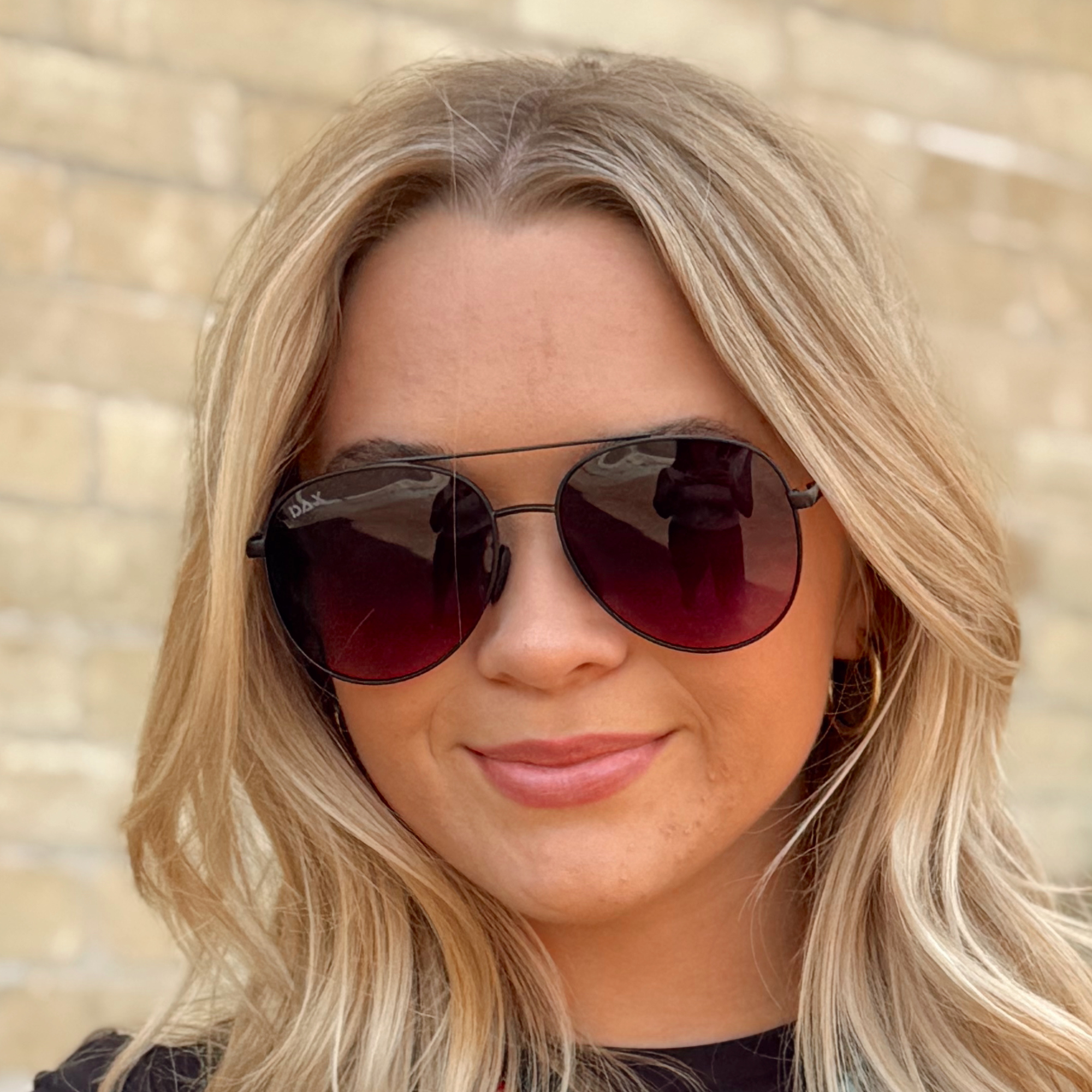 Woman wearing sunglasses with a blurred background