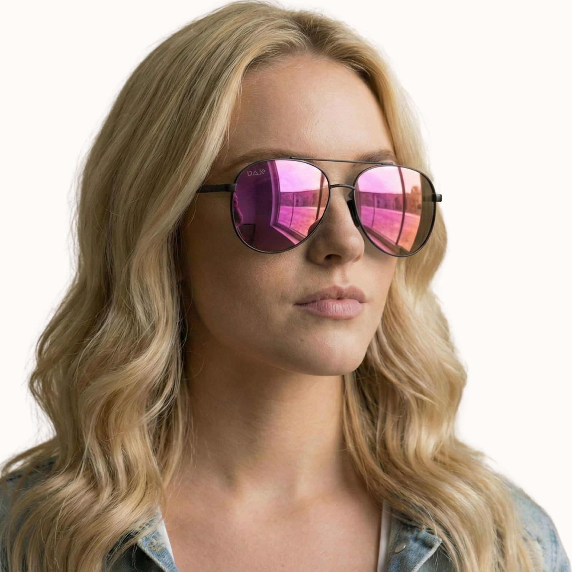 Woman wearing pink reflective sunglasses with a plain background