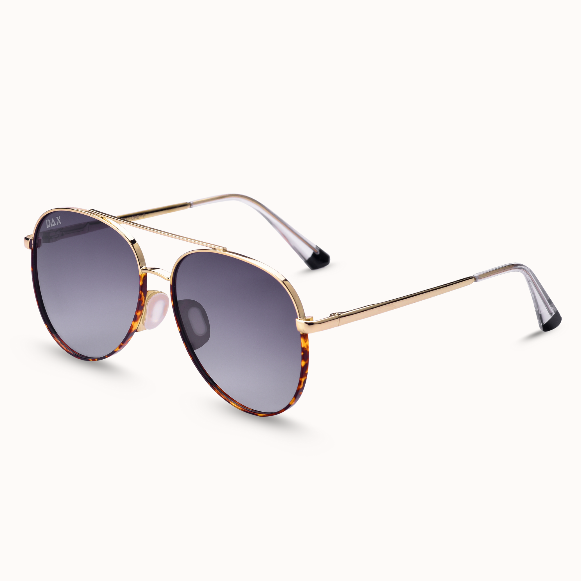 Sunglasses with gold frame and tortoiseshell accents on a white background