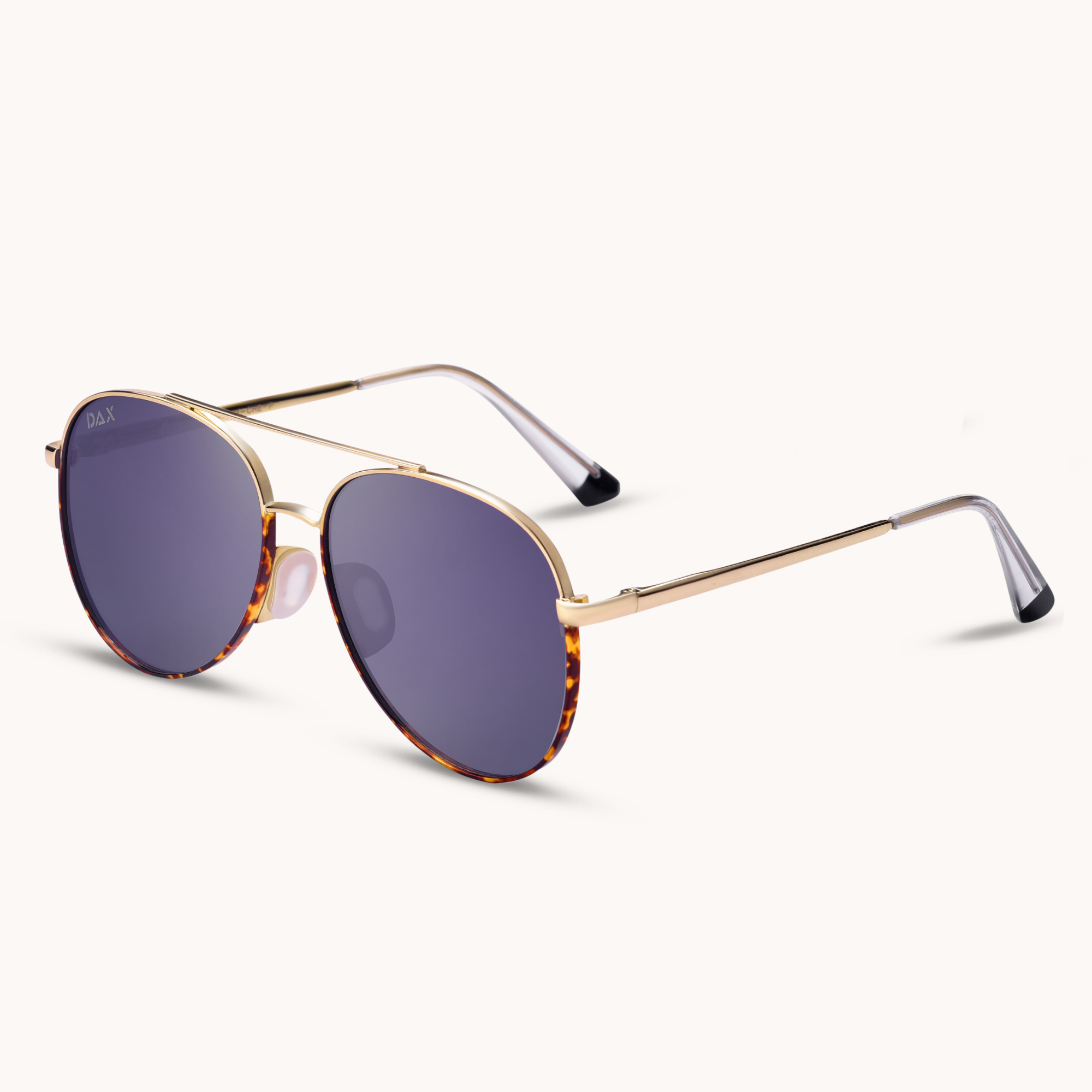 Sunglasses with gold frame and purple lenses on a white background