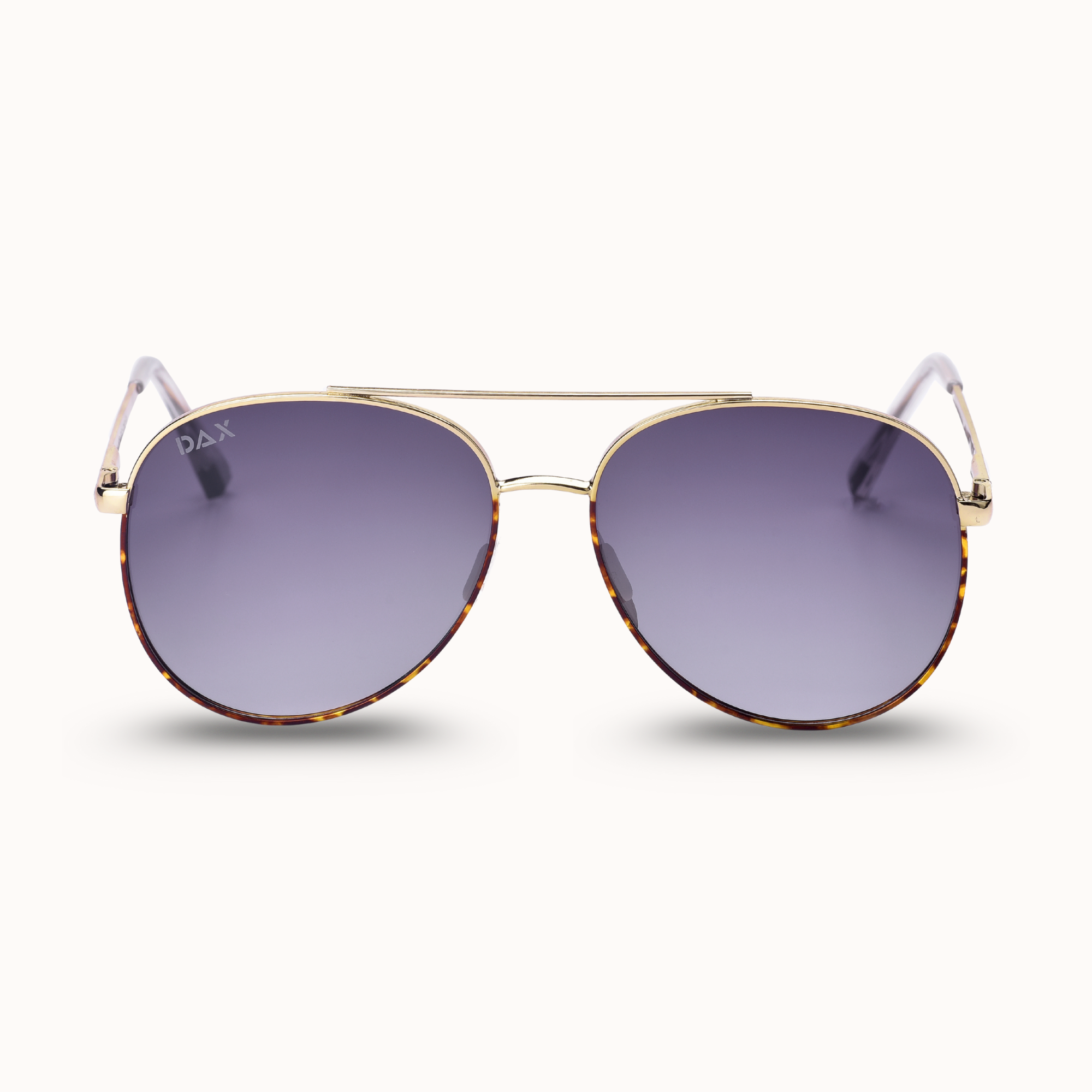 Sunglasses with gold frame and dark lenses on a white background