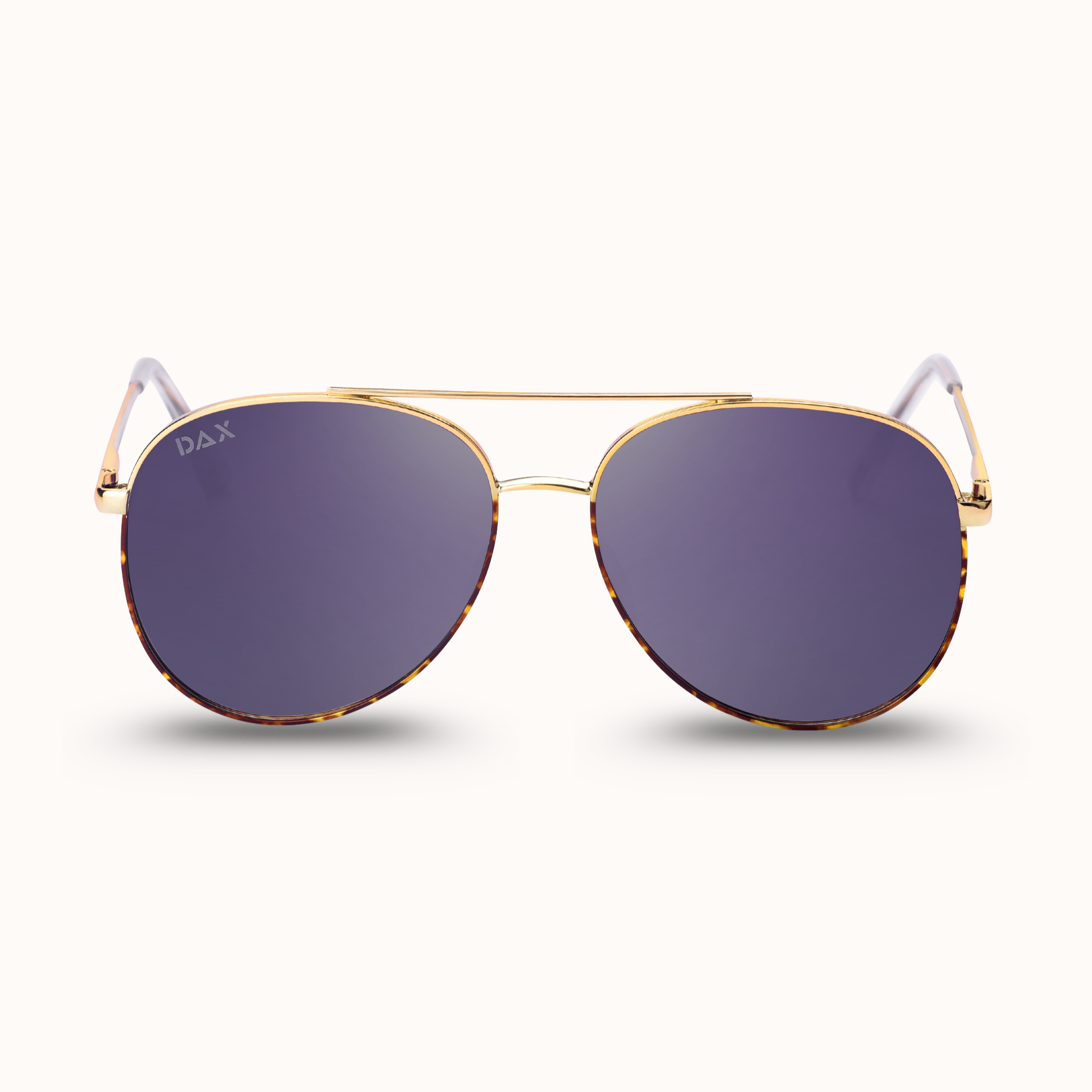 Gold-framed sunglasses with purple lenses on a white background