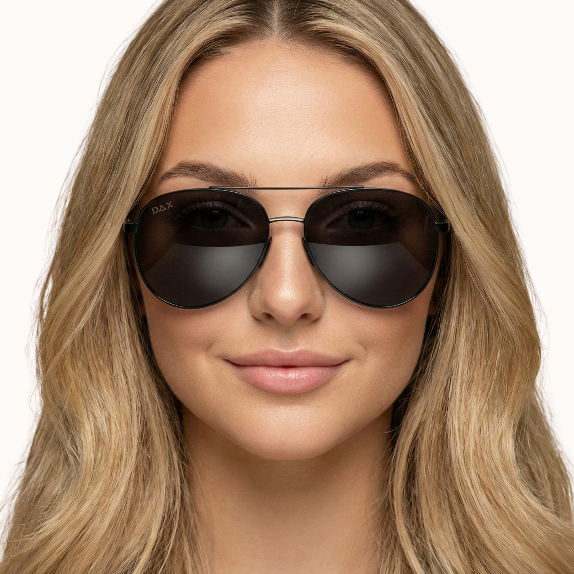 Woman wearing dark sunglasses with a plain background