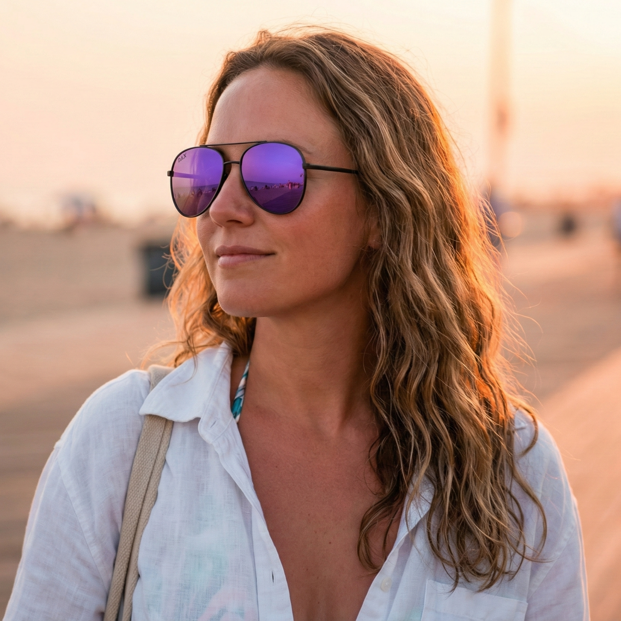 Woman wearing purple sunglasses with a blurred background