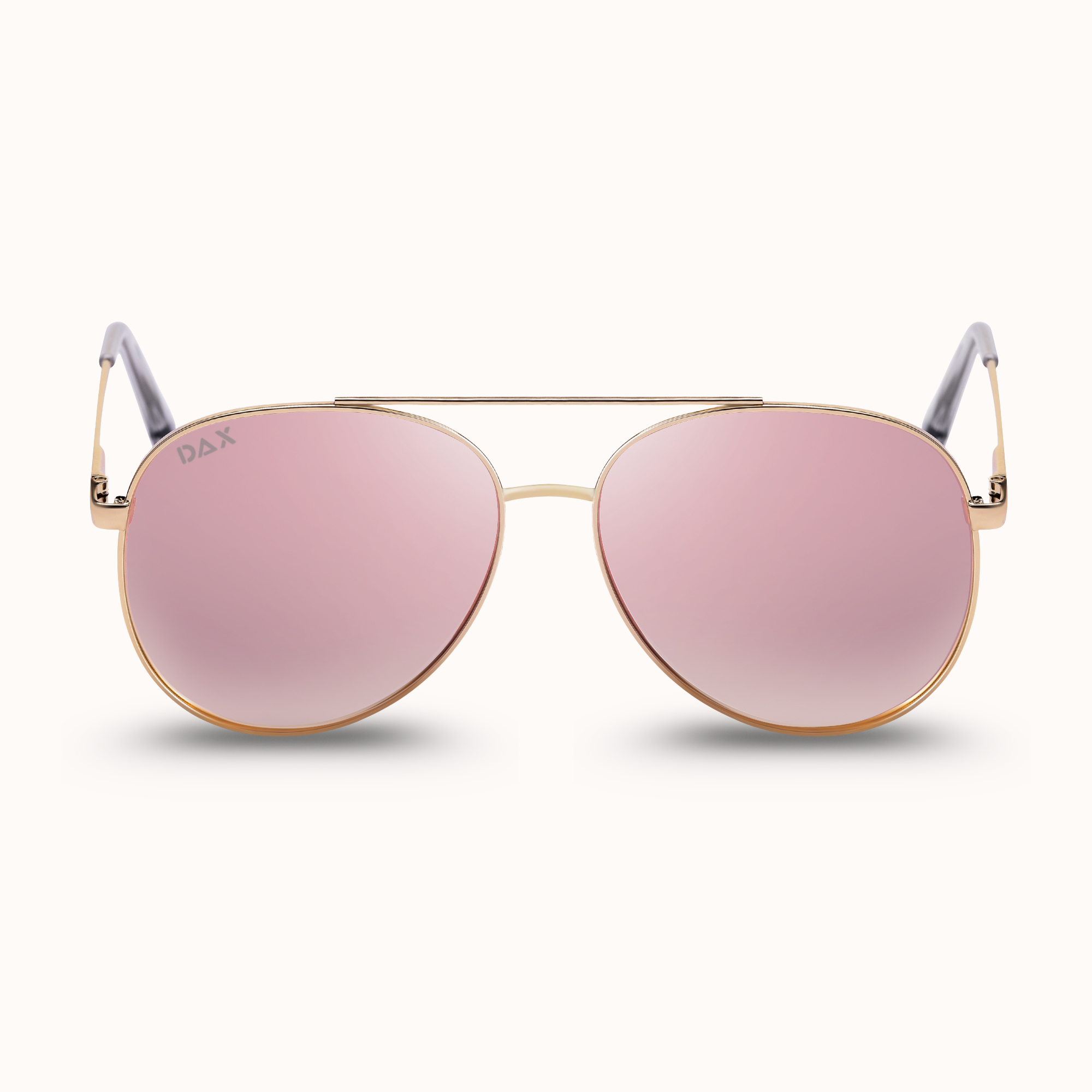 Aviator sunglasses with pink lenses and gold frames on a white background