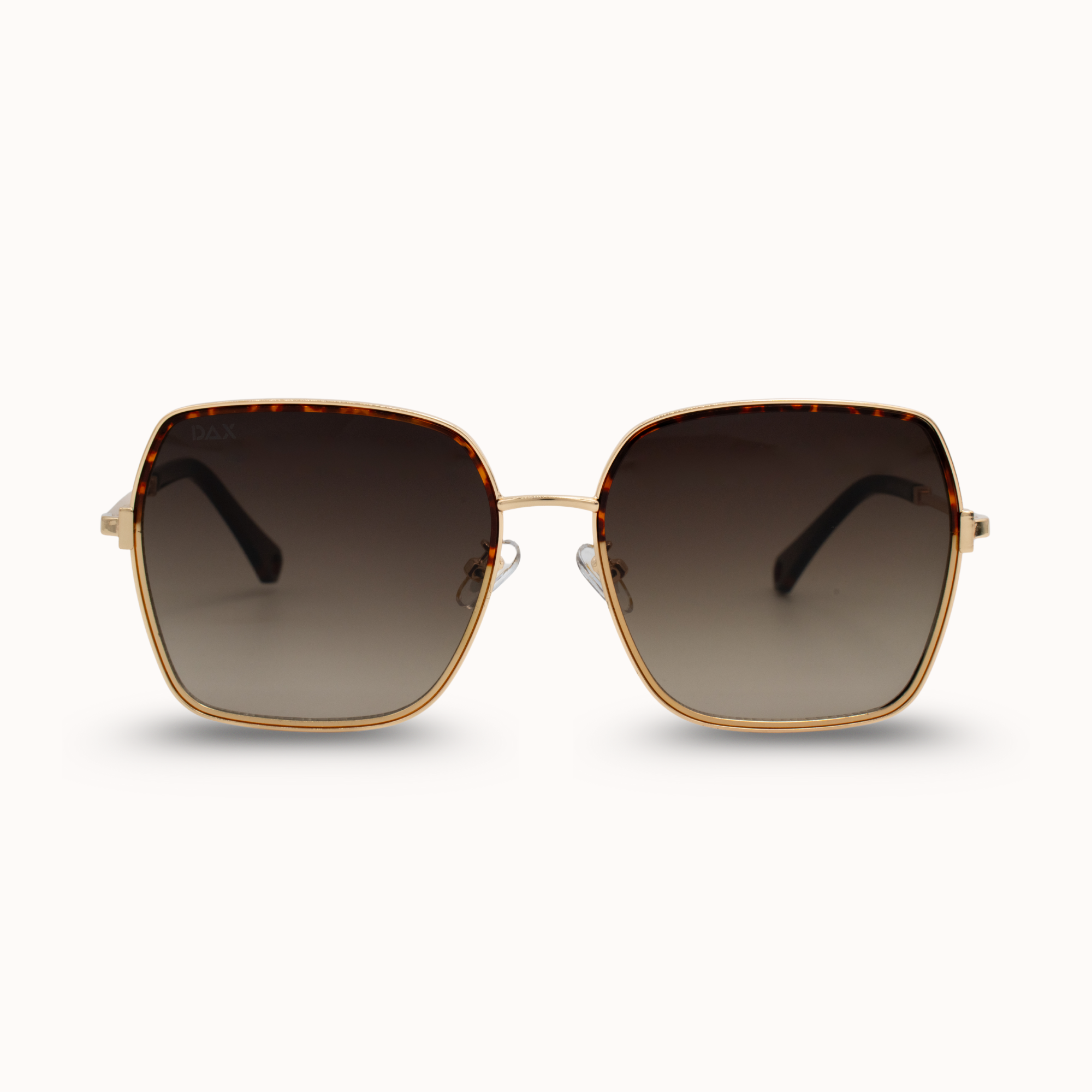 Sunglasses with gold frame and dark lenses on a white background