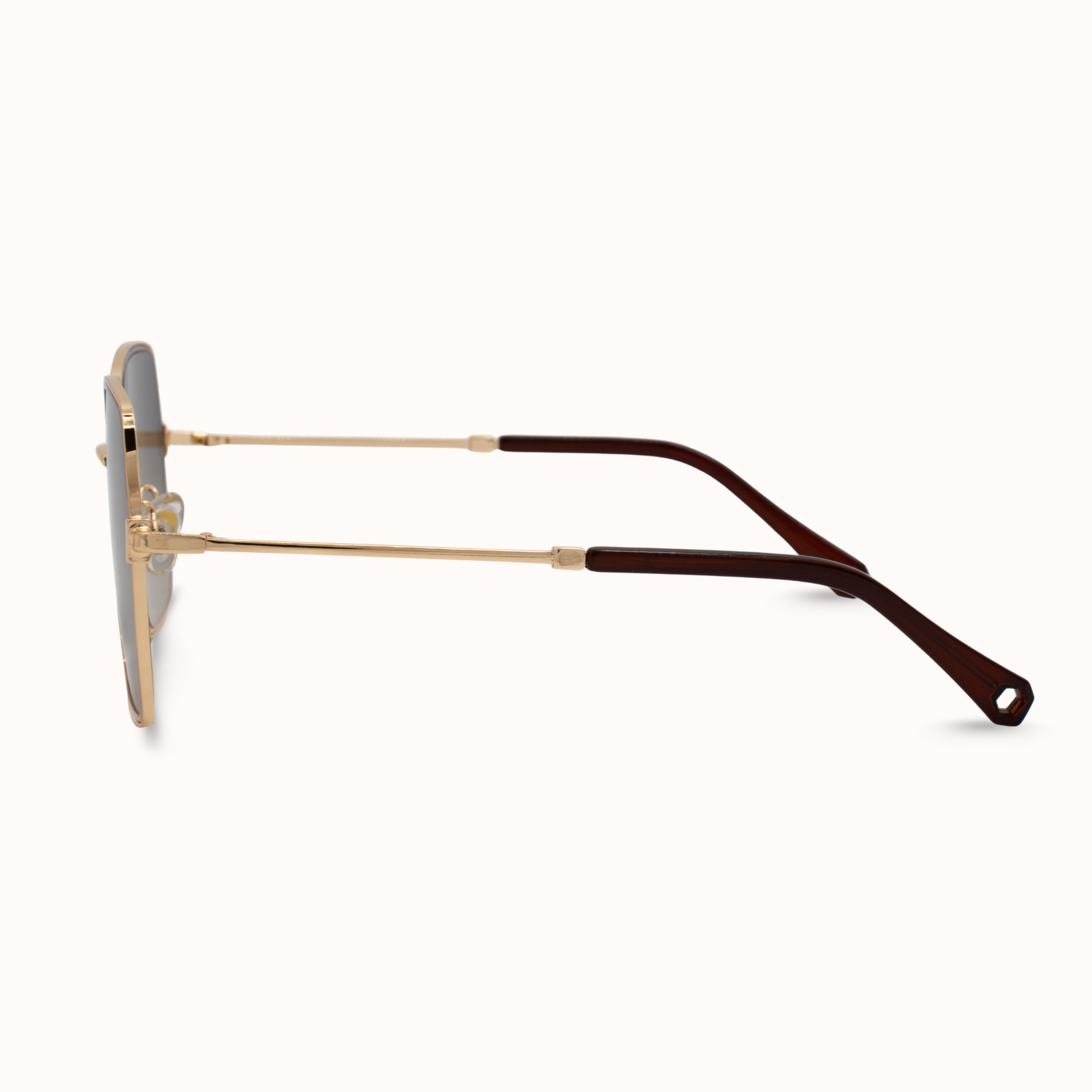 Sunglasses with gold frame and brown arm on a white background