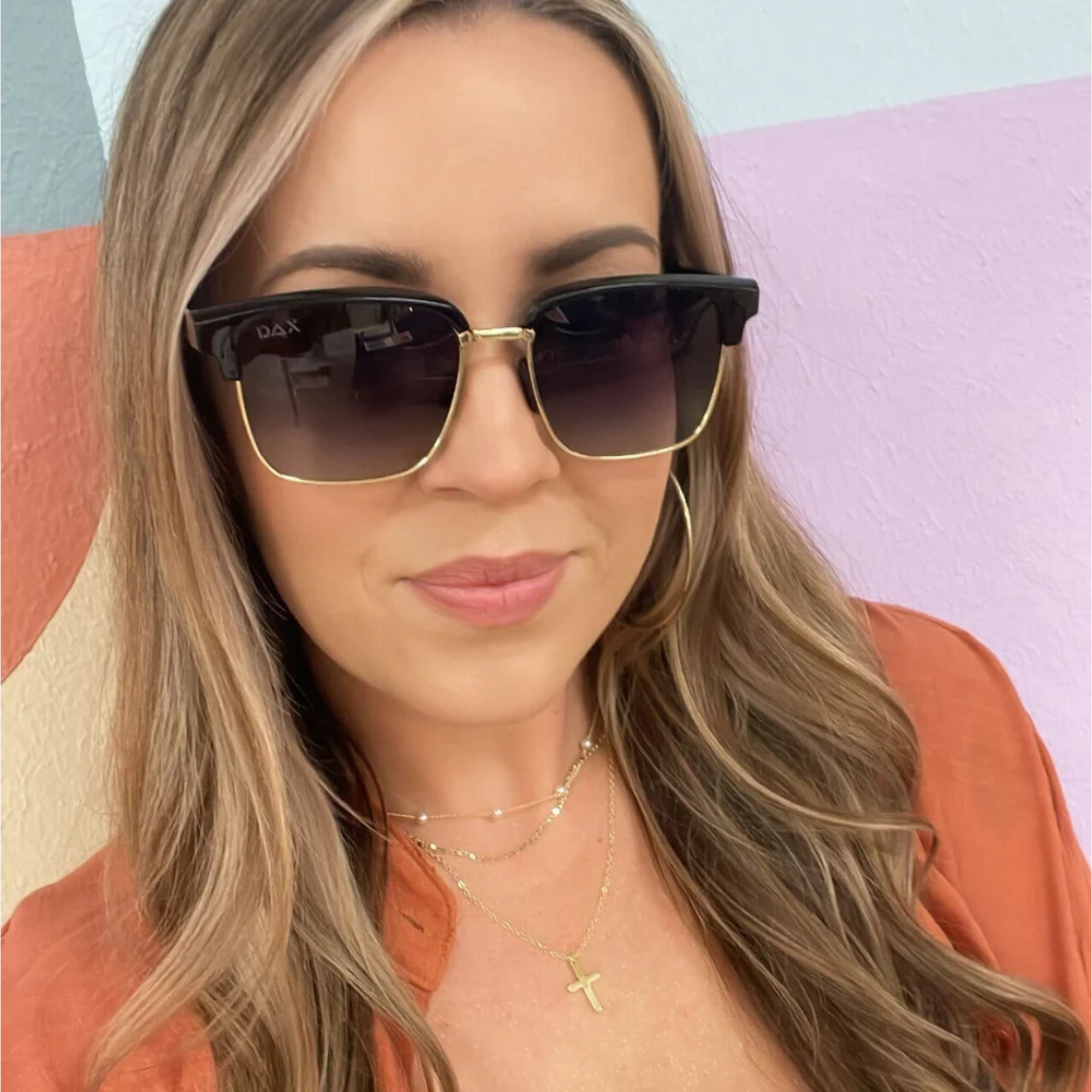 Woman wearing sunglasses with a colorful background