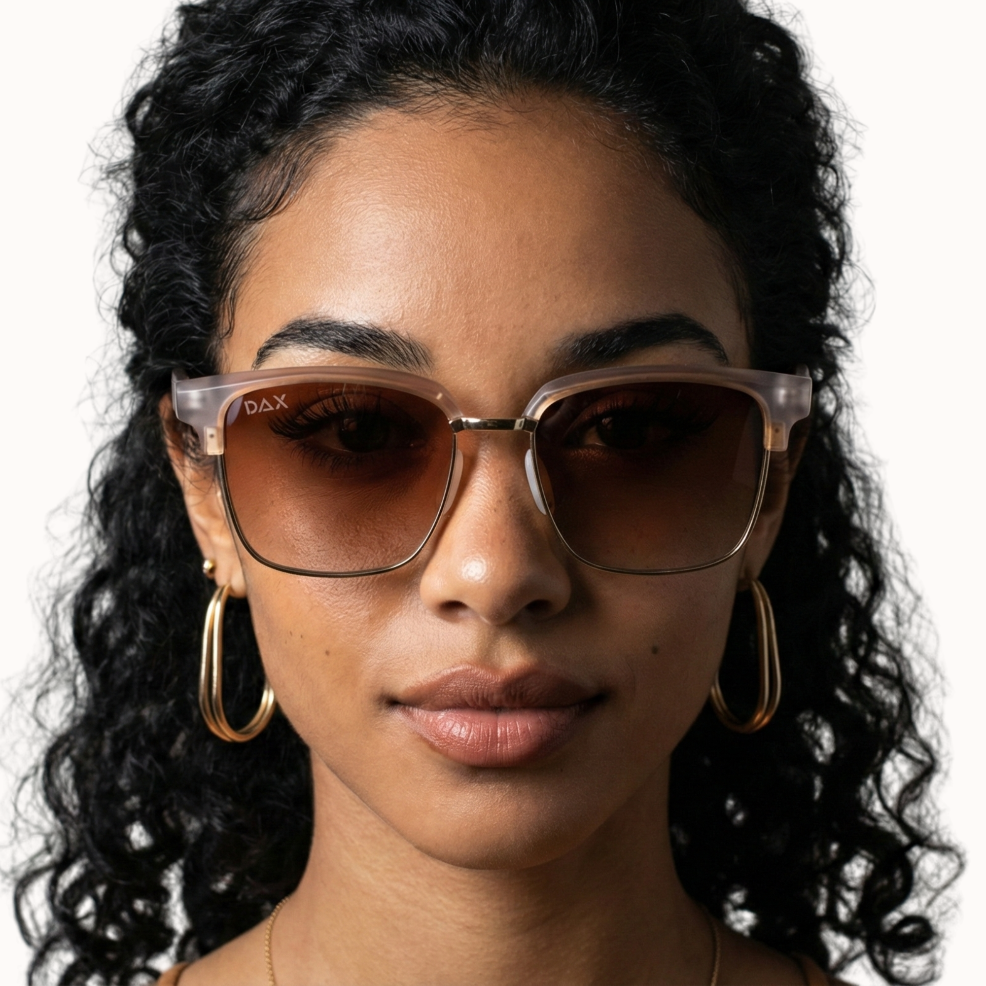 Woman wearing sunglasses with a neutral background