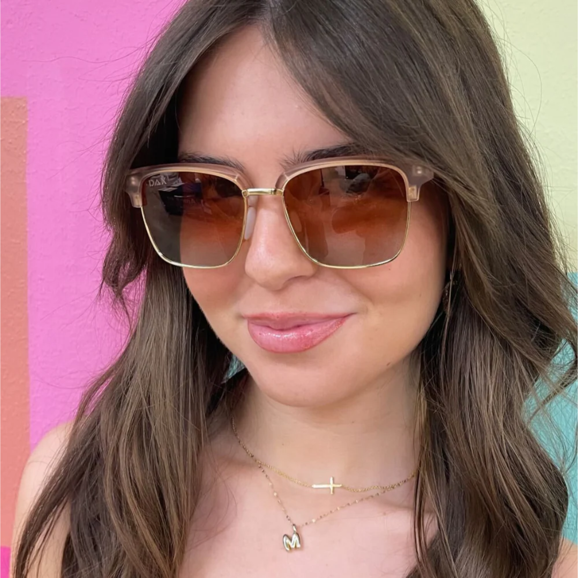 Woman wearing sunglasses with a colorful background
