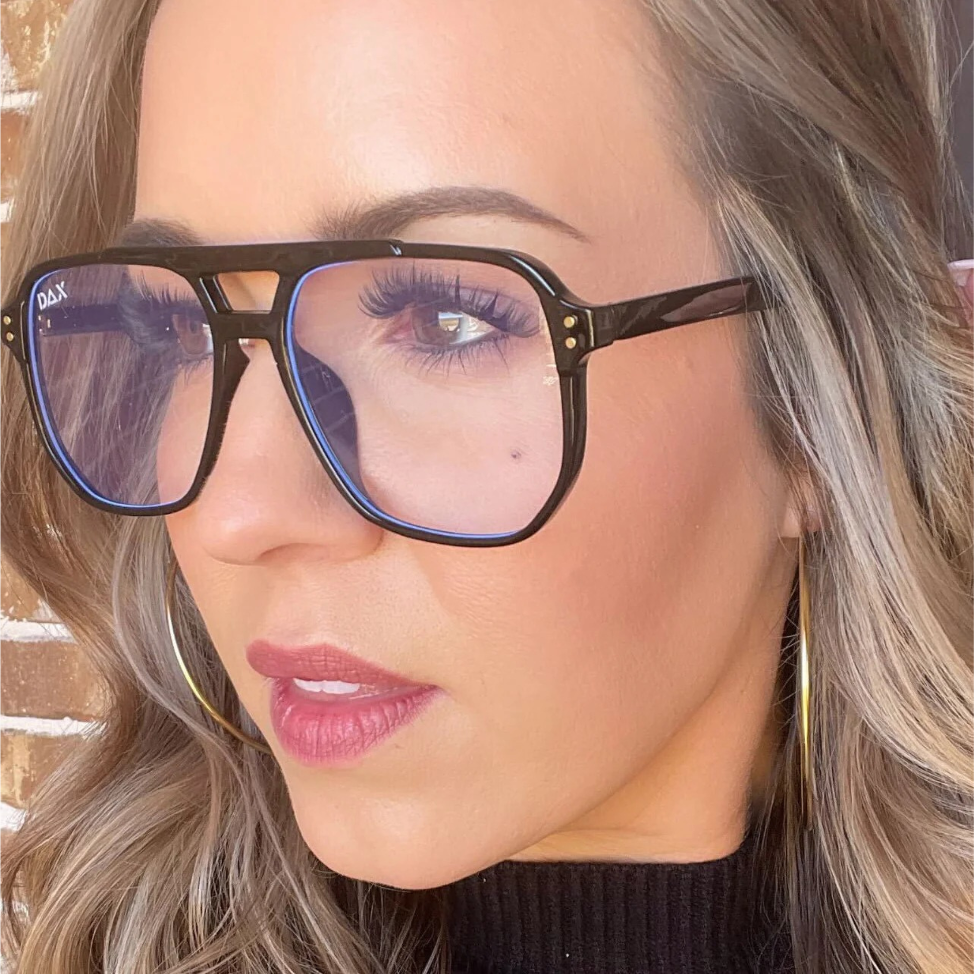 Close-up of a person wearing glasses with a blurred background