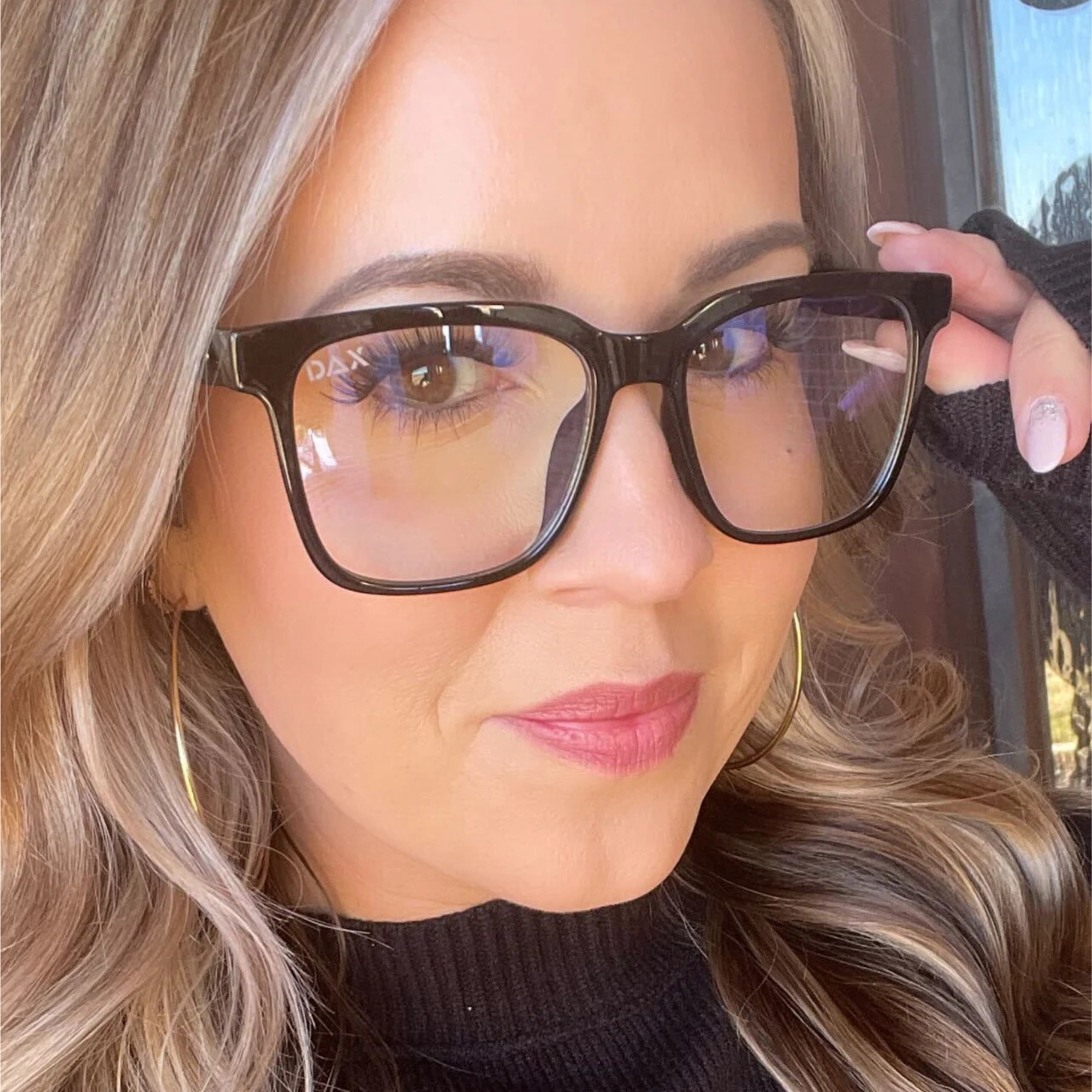 Close-up of a person wearing glasses with a blurred background