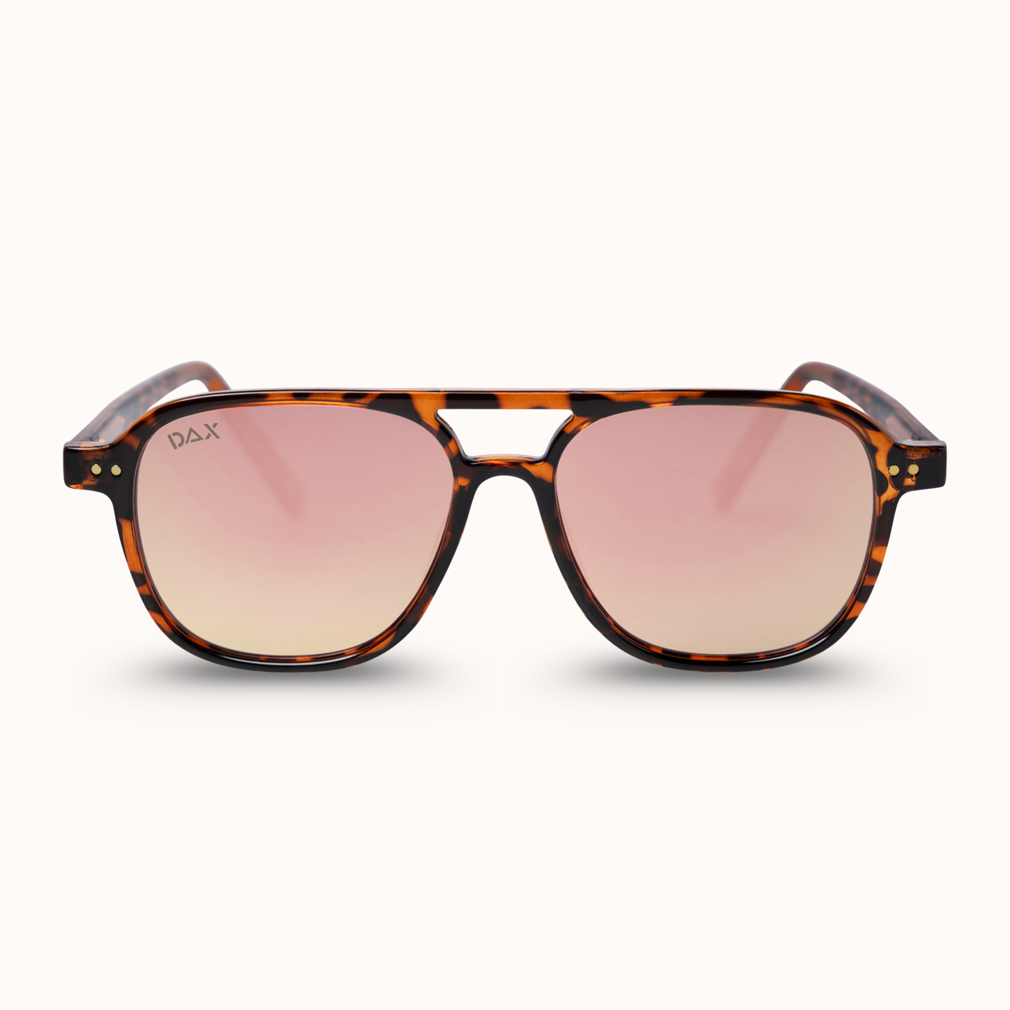 A pair of DAX brand sunglasses with a classic brown and black tortoiseshell frame and pink gradient lenses, shown against a clean off-white background.
