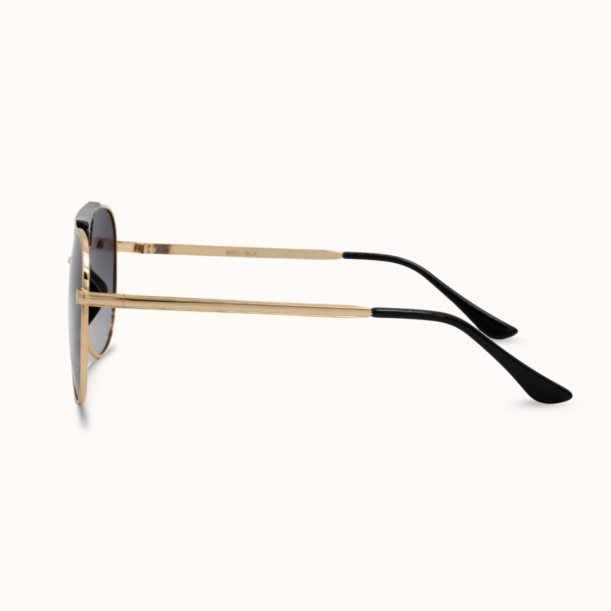 Sunglasses with gold frame and black arms on a white background