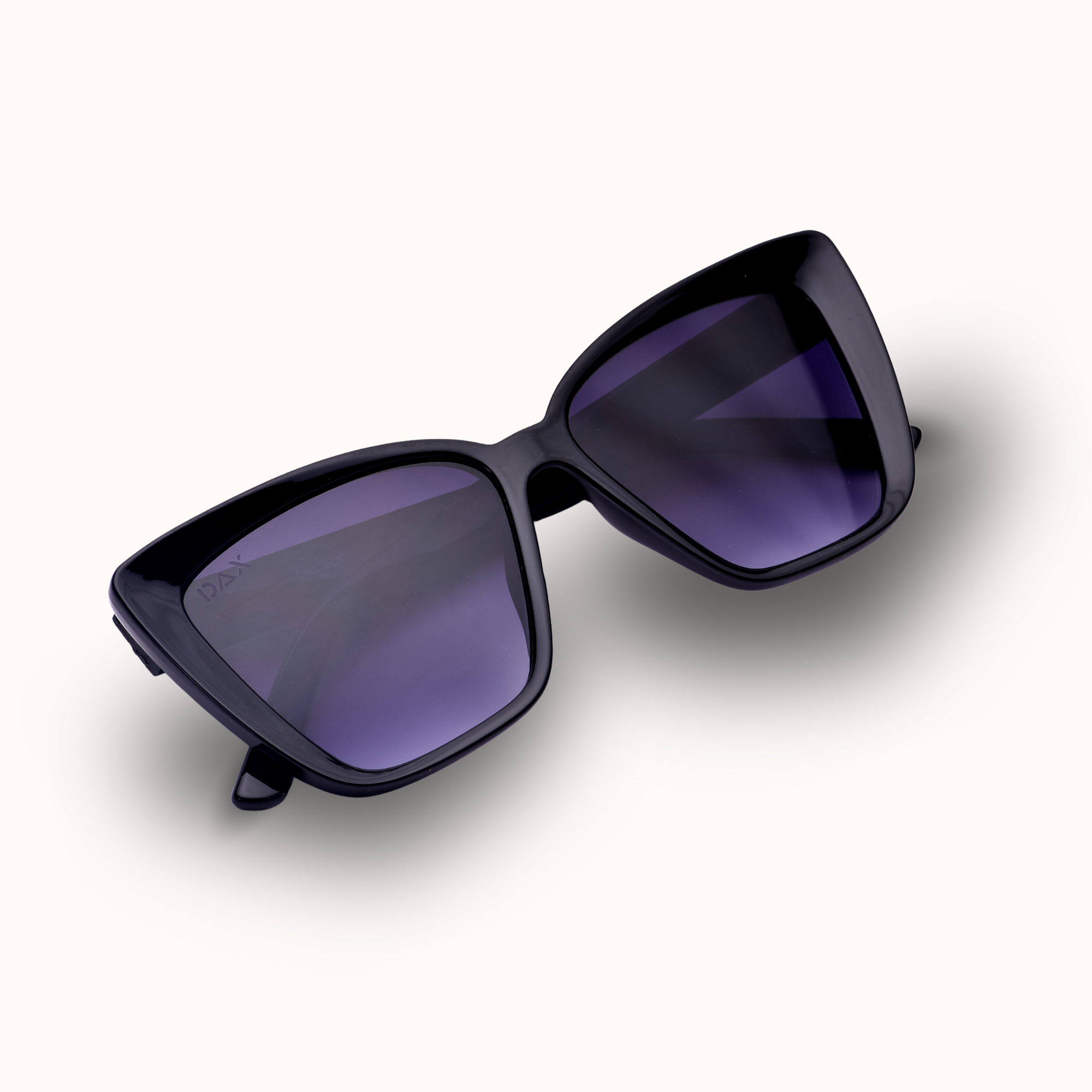 Black sunglasses with purple lenses on a white background
