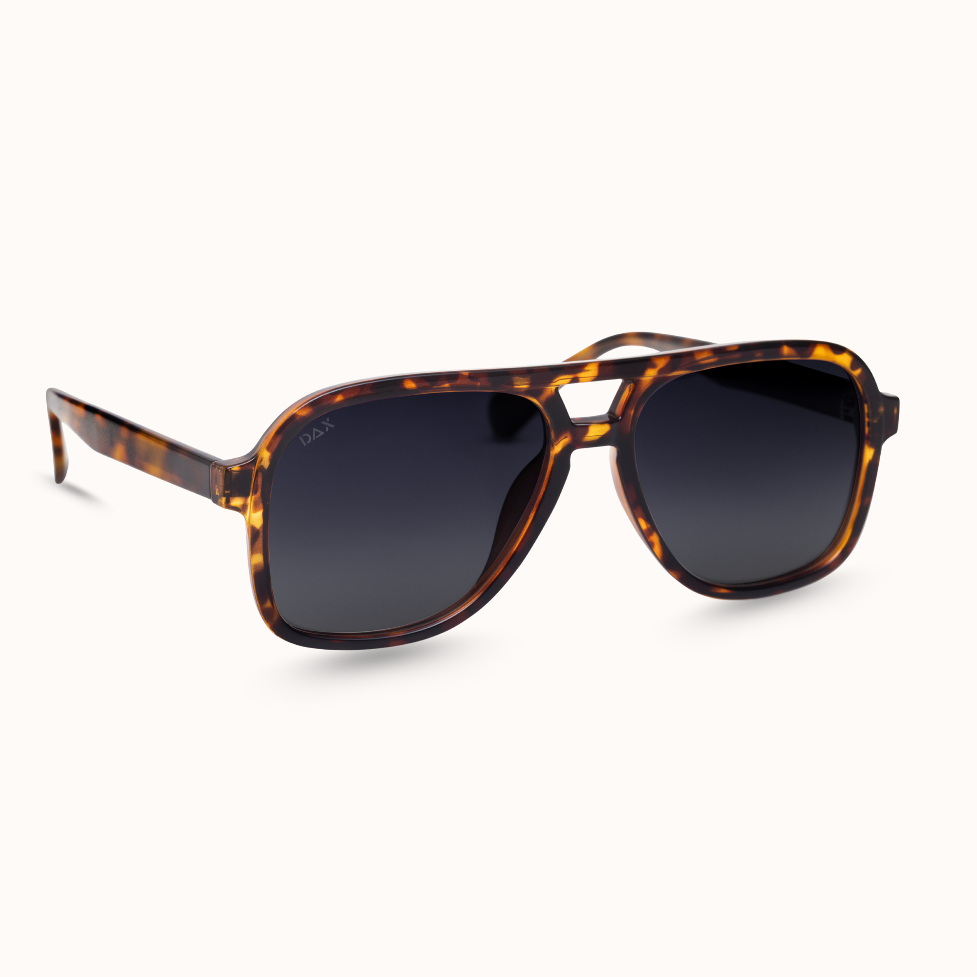 Sunglasses with tortoiseshell frame and dark lenses on a white background