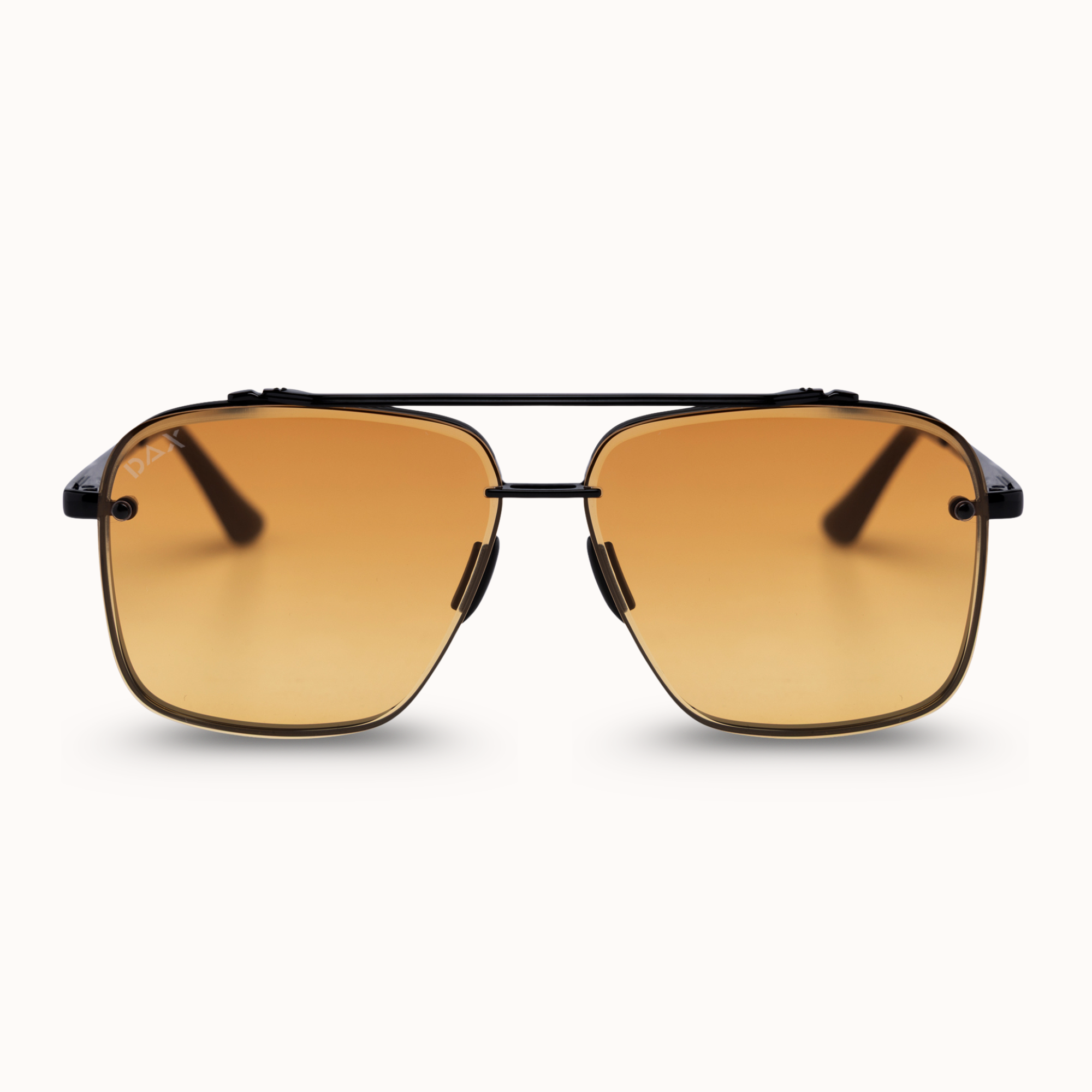 A pair of aviator-style sunglasses with a thin black metal frame and warm gradient amber lenses, shown against a clean off-white background.