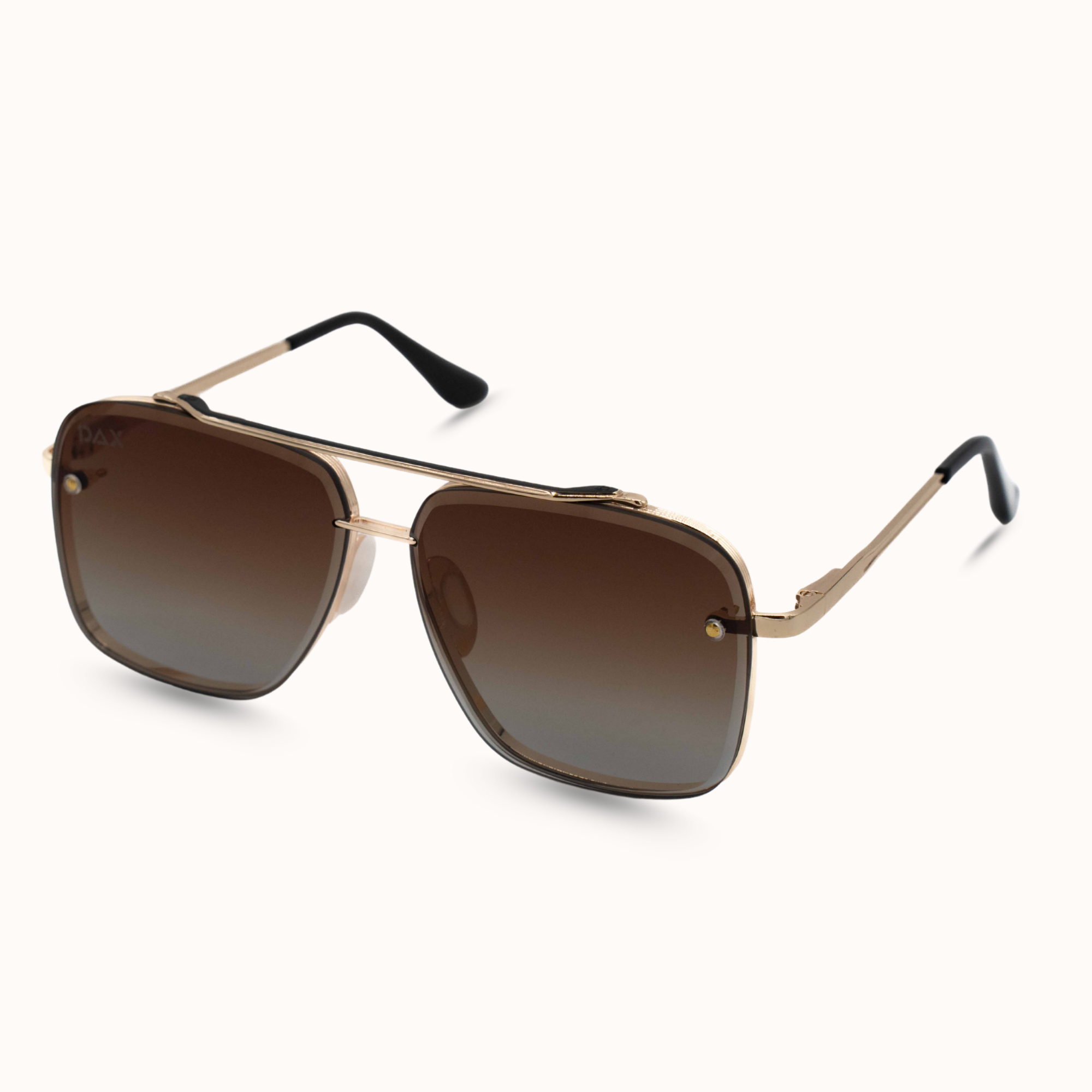 Sunglasses with gold frame and brown gradient lenses on a white background