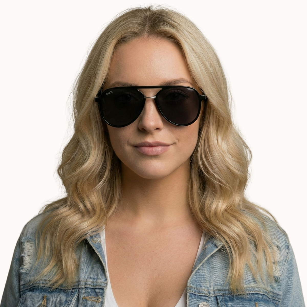 Woman wearing sunglasses with a denim jacket on a white background