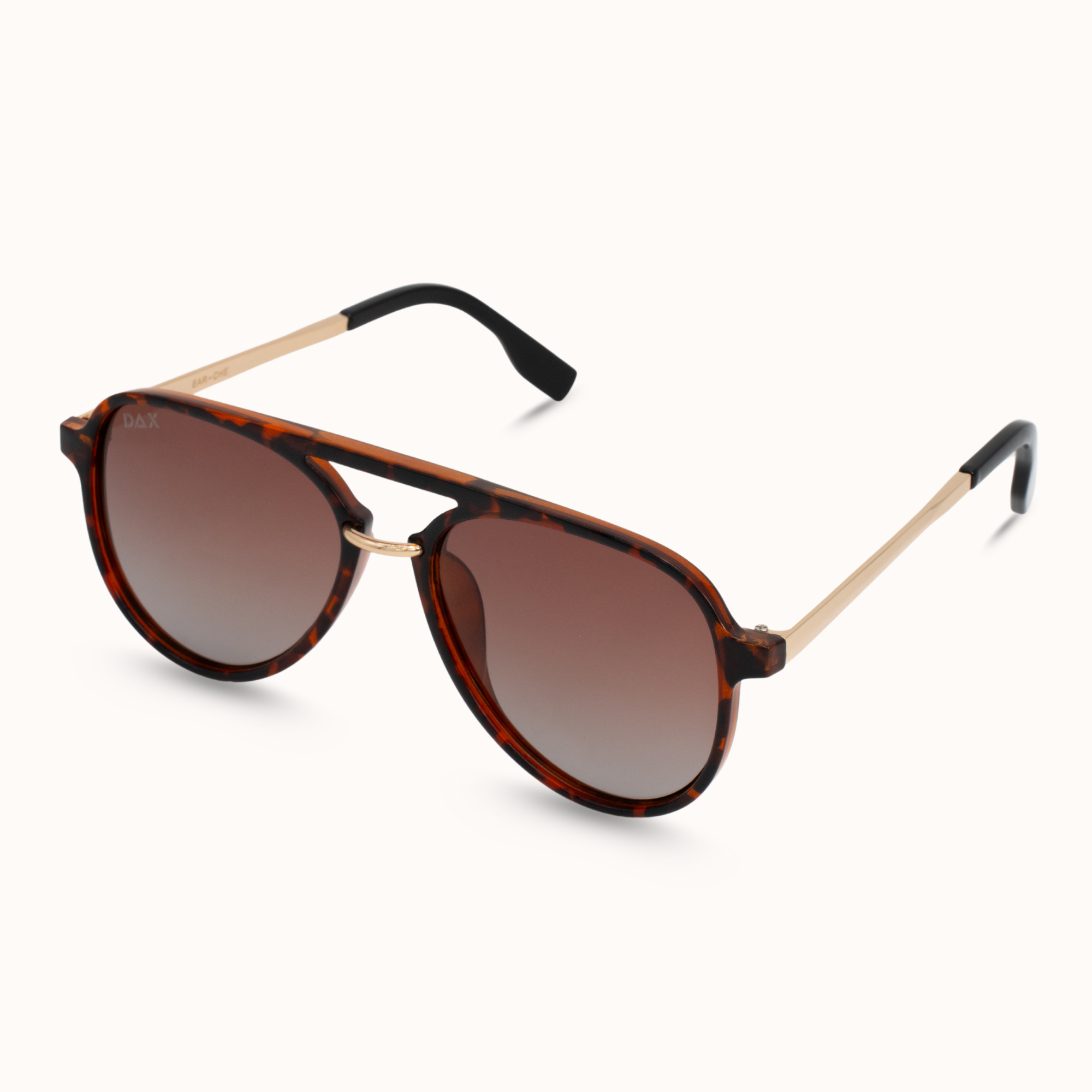 Sunglasses with tortoiseshell frame and brown lenses on a white background