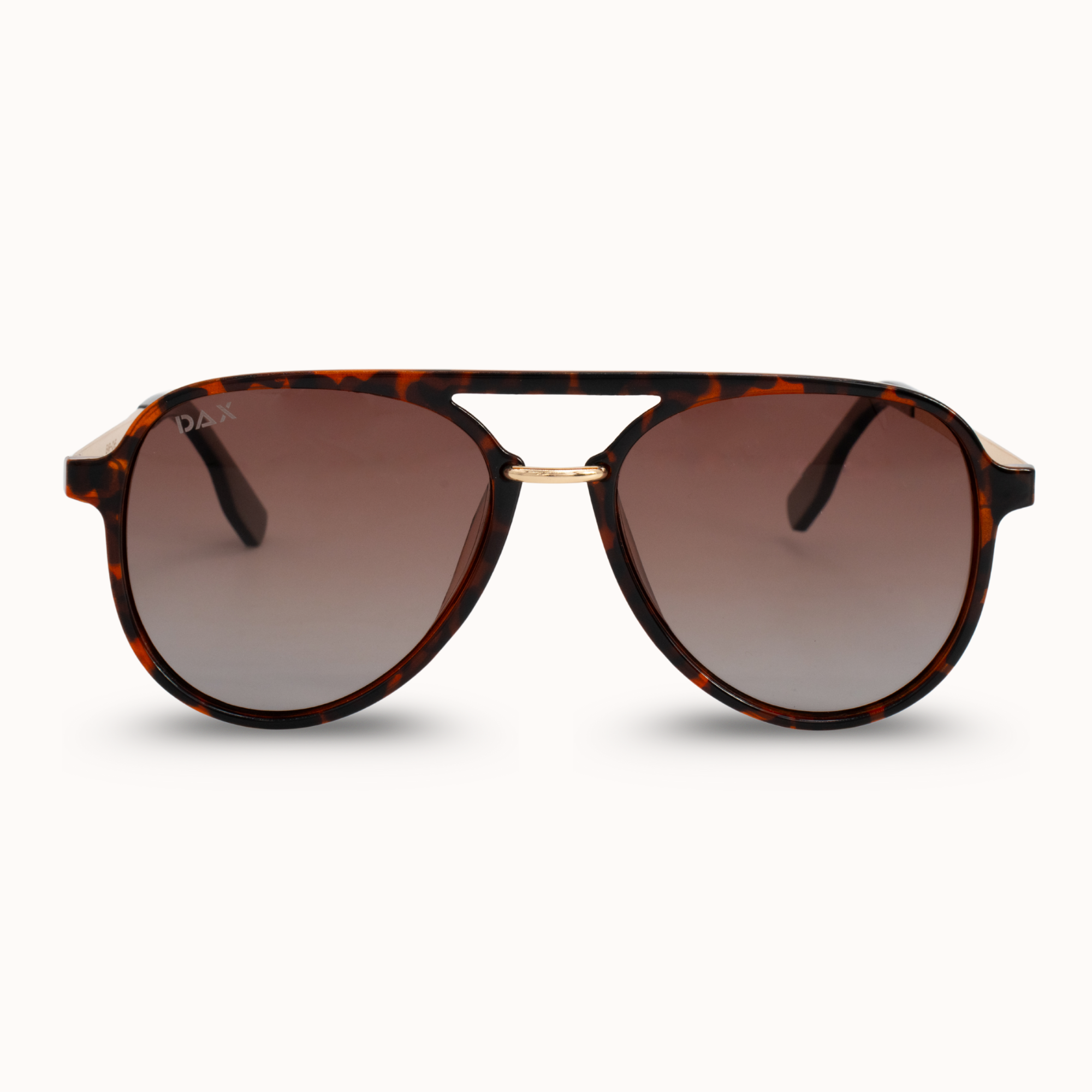 Sunglasses with tortoiseshell frame and brown gradient lenses on a white background