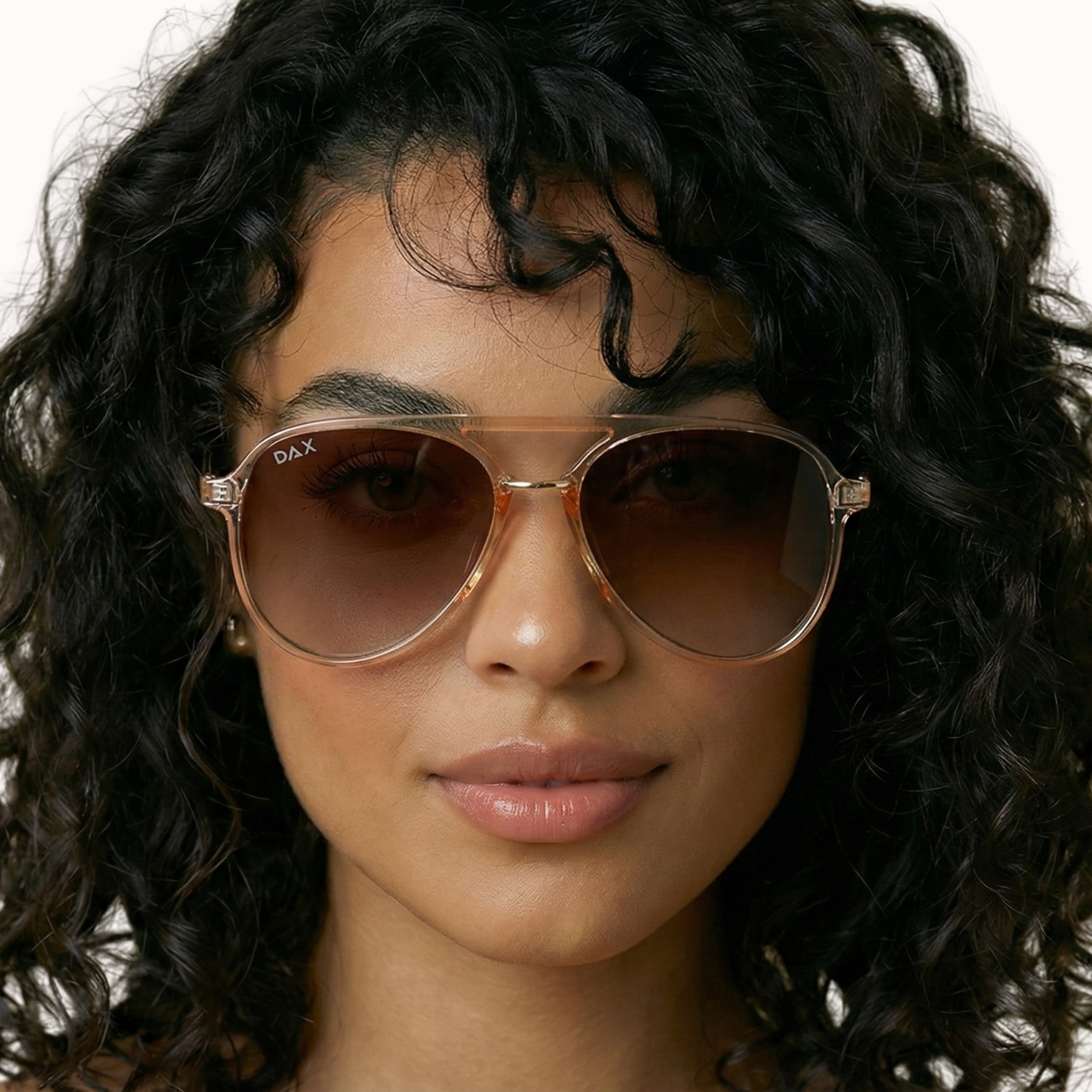 Woman wearing sunglasses with a neutral background