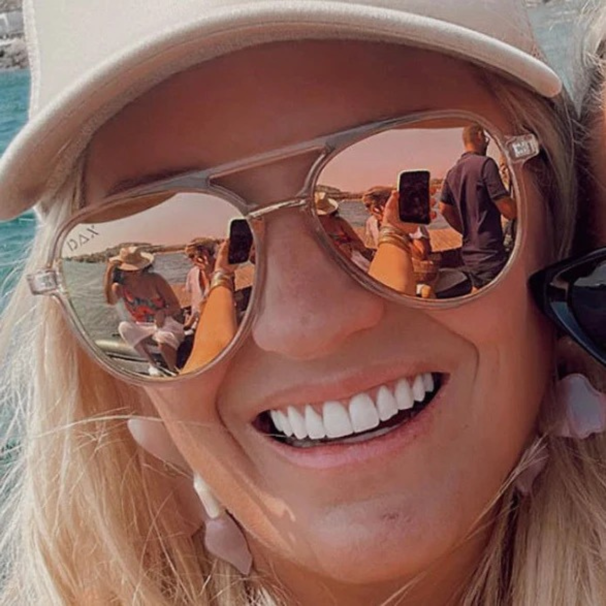 Person wearing reflective sunglasses with a scenic background