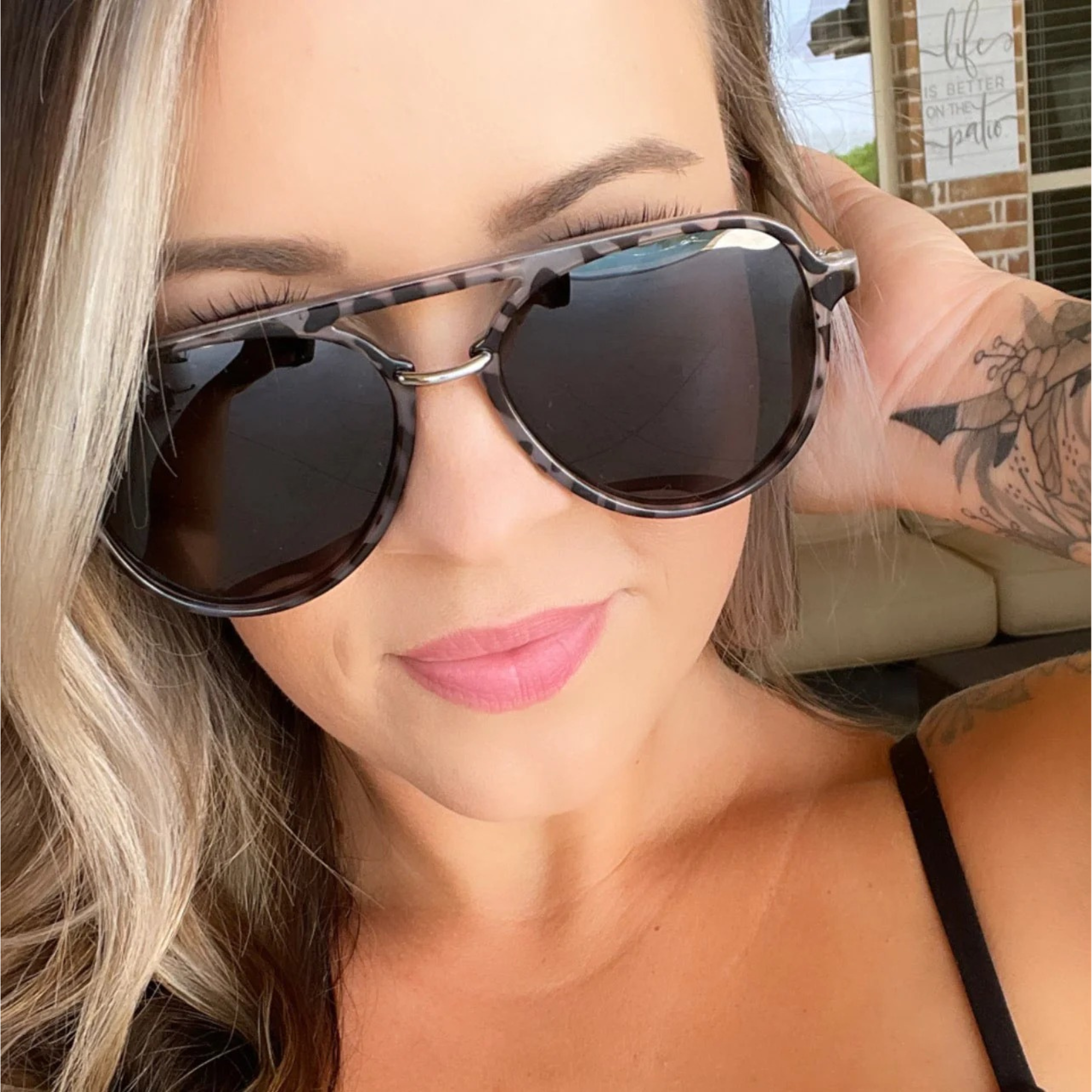 Woman wearing sunglasses with a blurred background