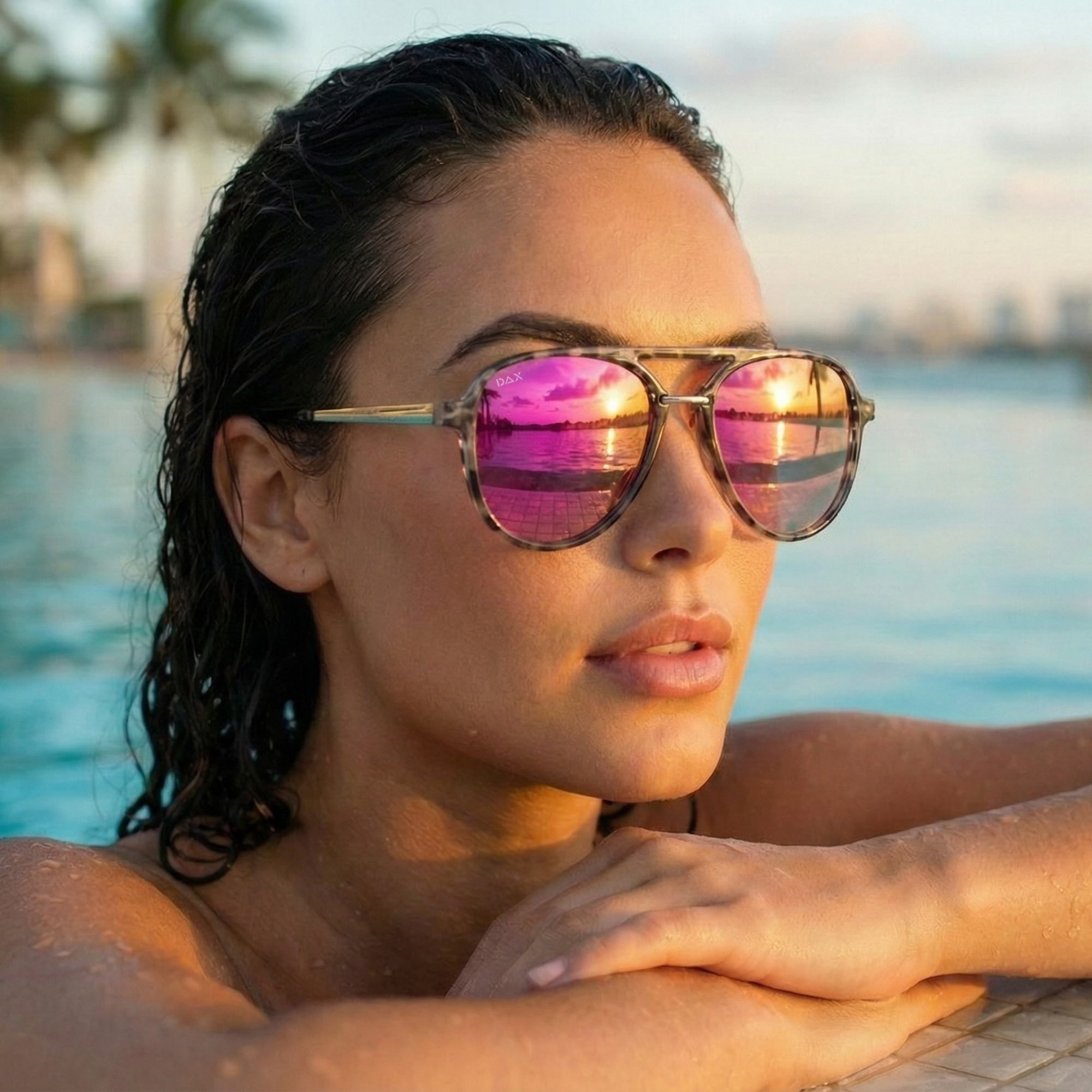 Woman wearing pink-tinted sunglasses by a pool