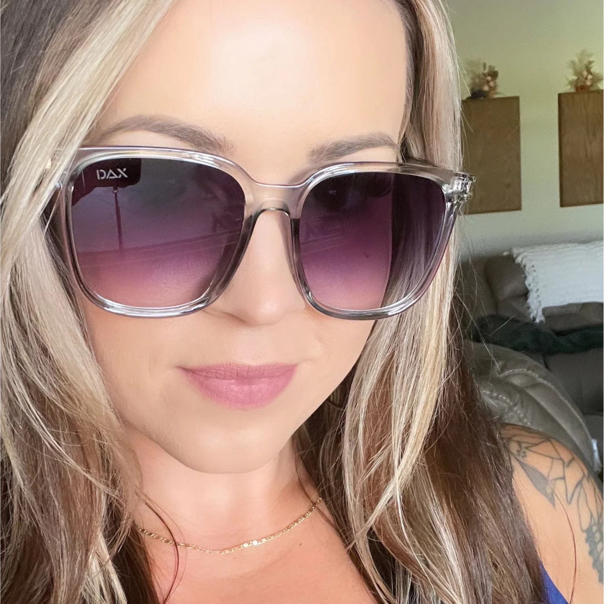 Woman wearing DAX sunglasses indoors