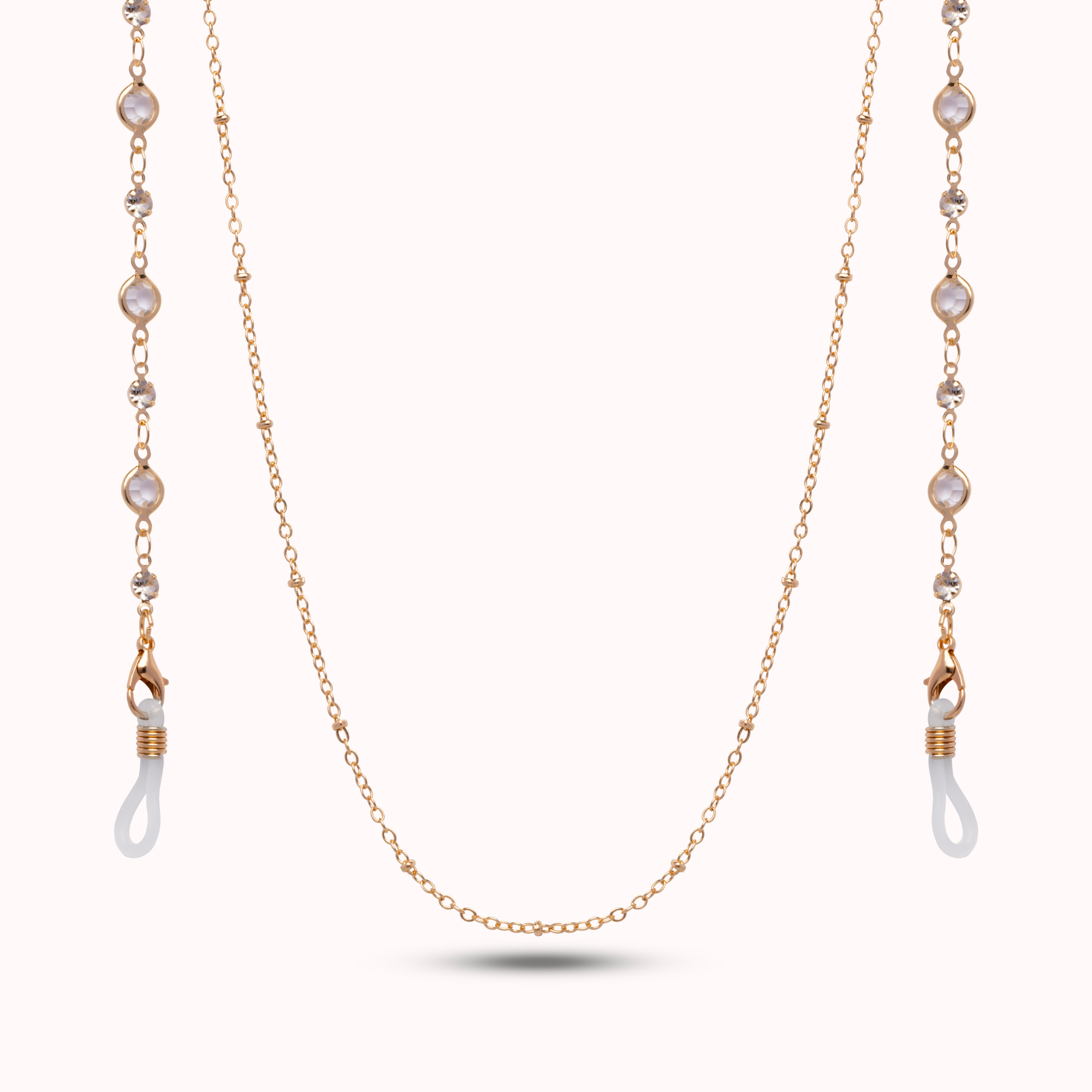 Gold chain with pearl-like beads on a white background
