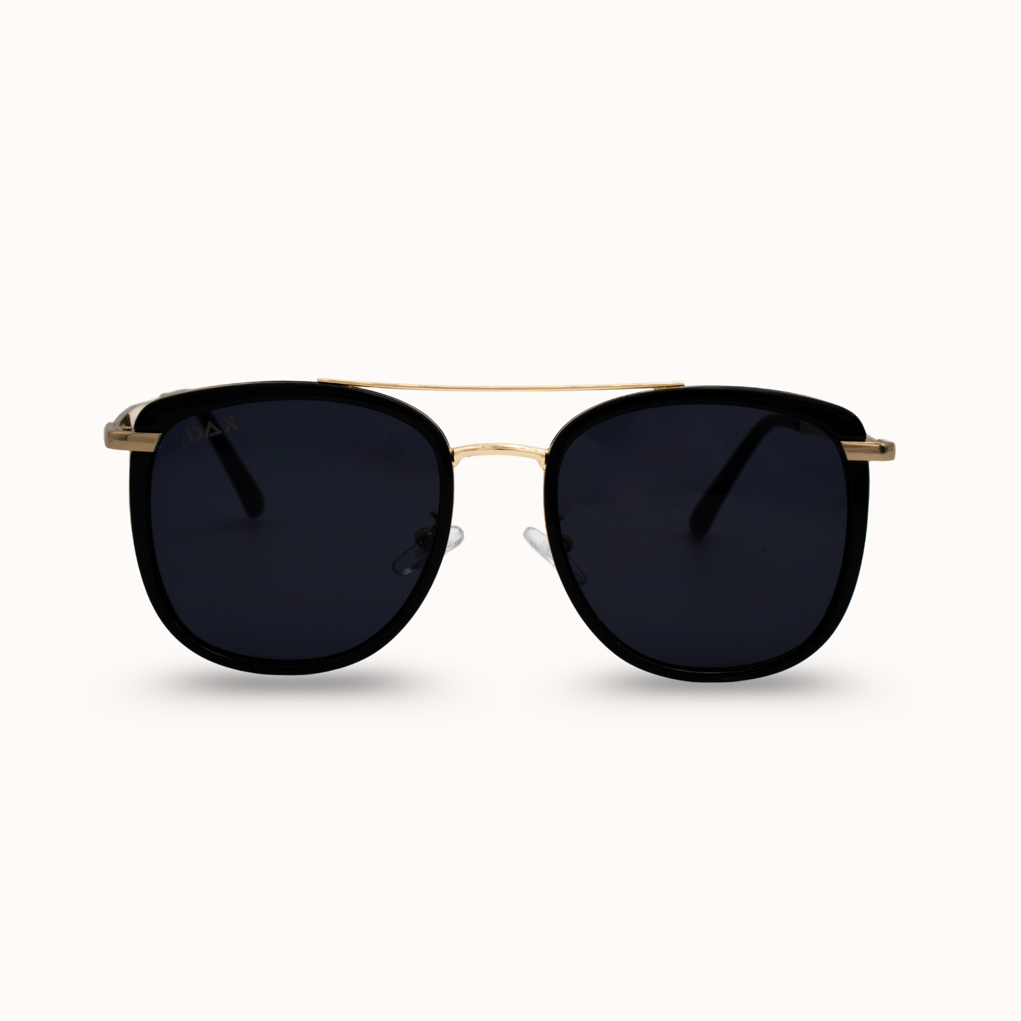 Sunglasses with black lenses and gold frame on a white background