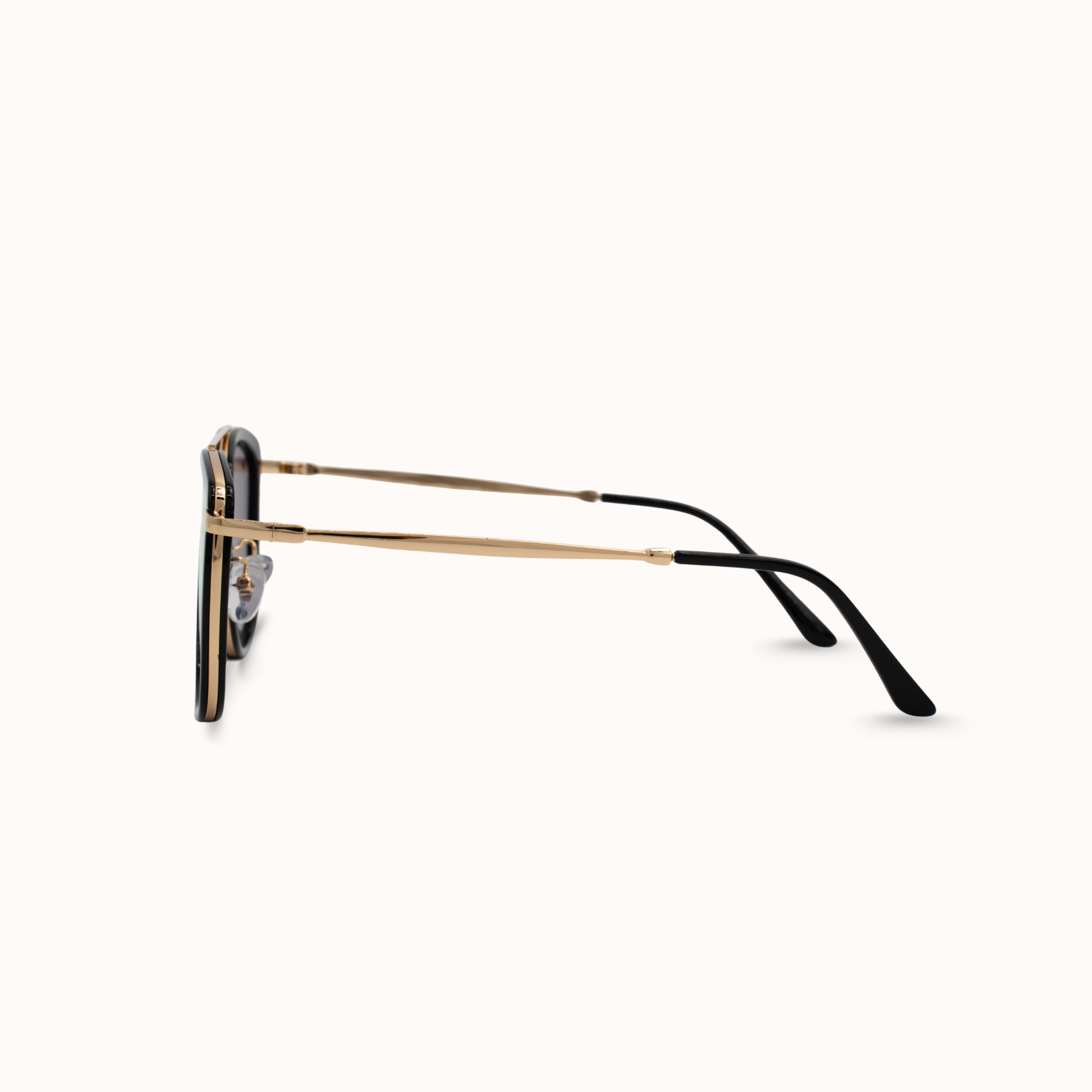 Sunglasses with gold frame and black arms on a white background