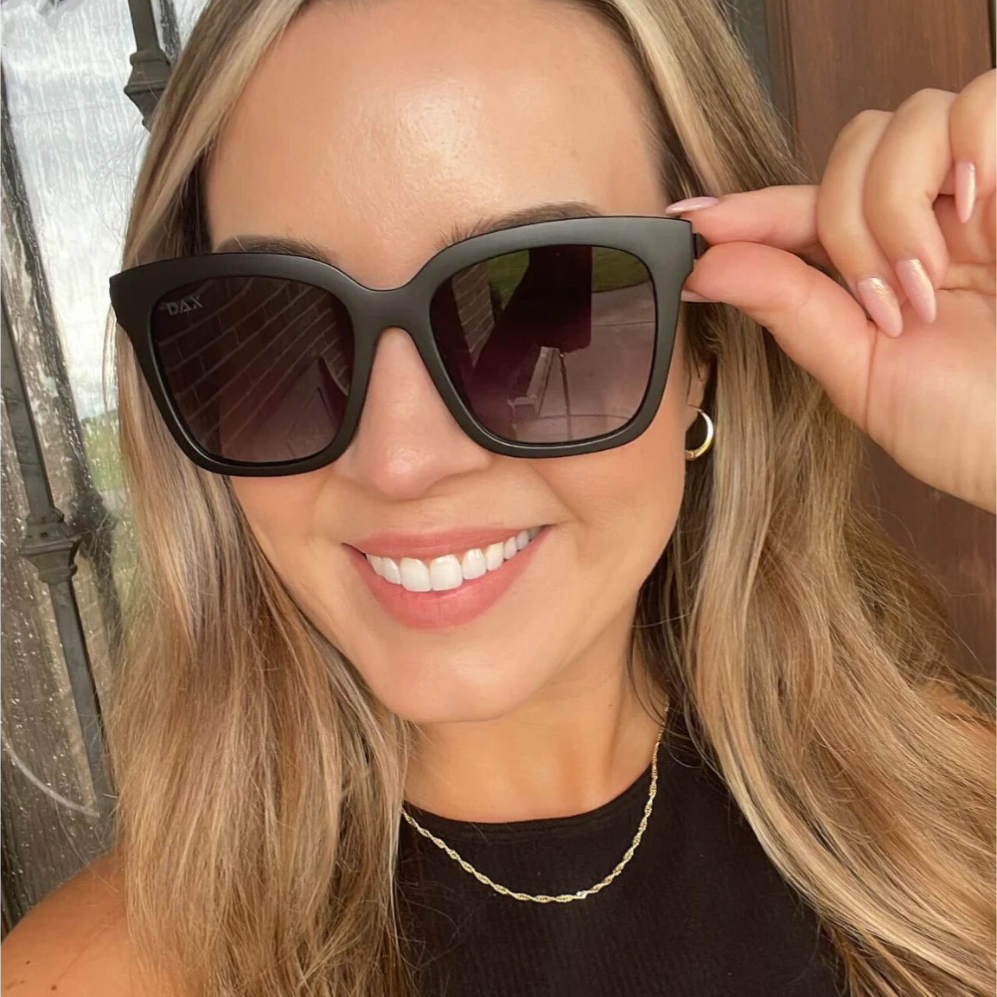 Woman wearing sunglasses with a blurred background