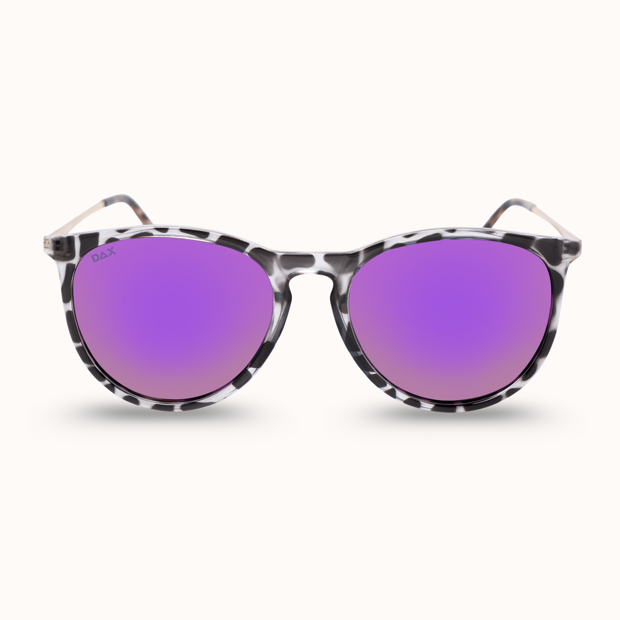 Oversized sunglasses with a black and white leopard print acetate frame and vibrant purple mirrored lenses, shown against a light cream background.