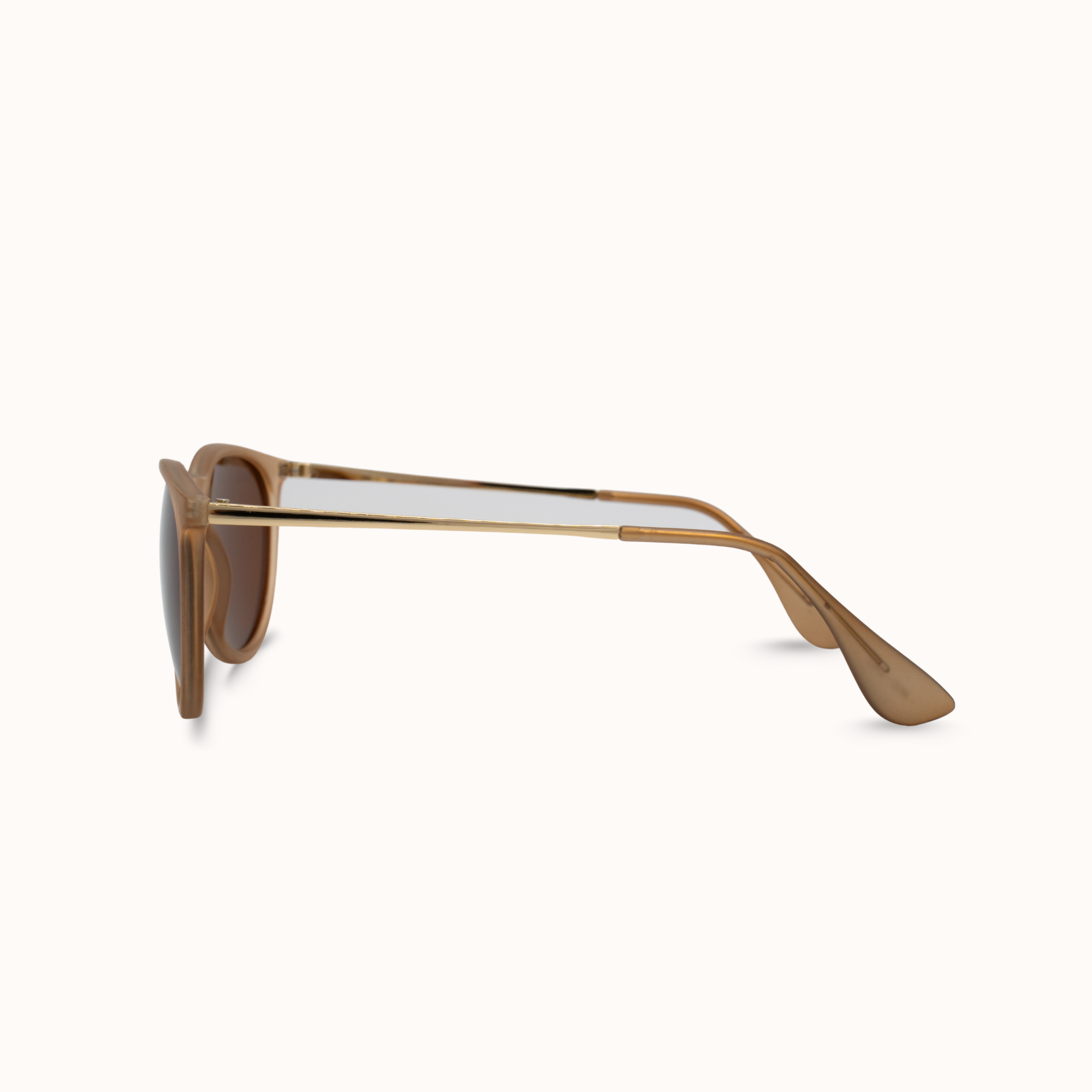 Sunglasses with gold frame and brown lenses on a white background