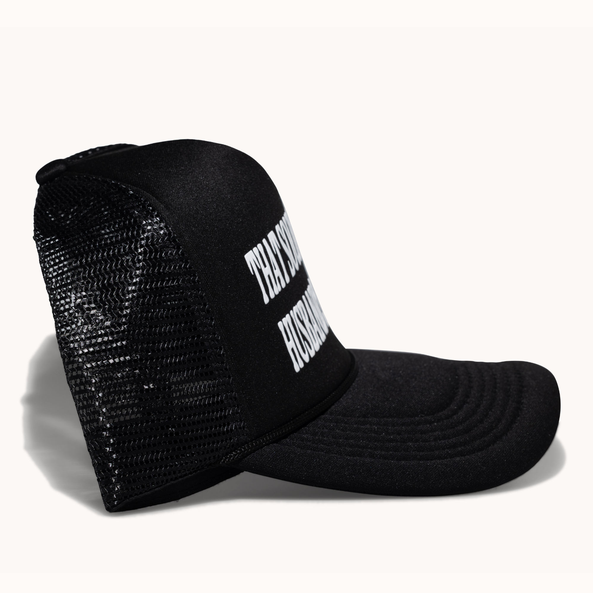 Black mesh cap with white text on a white background