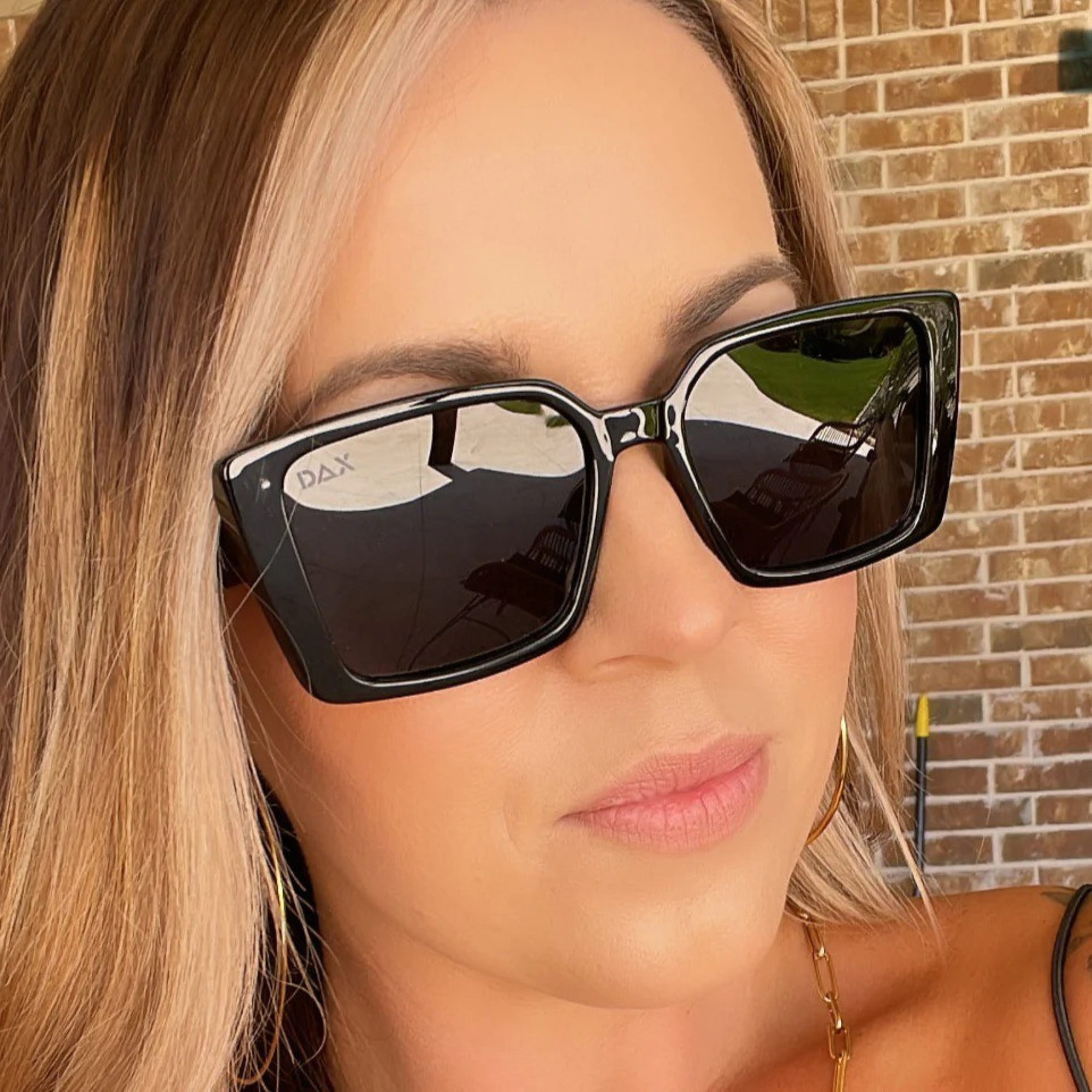 Person wearing black sunglasses with a blurred background