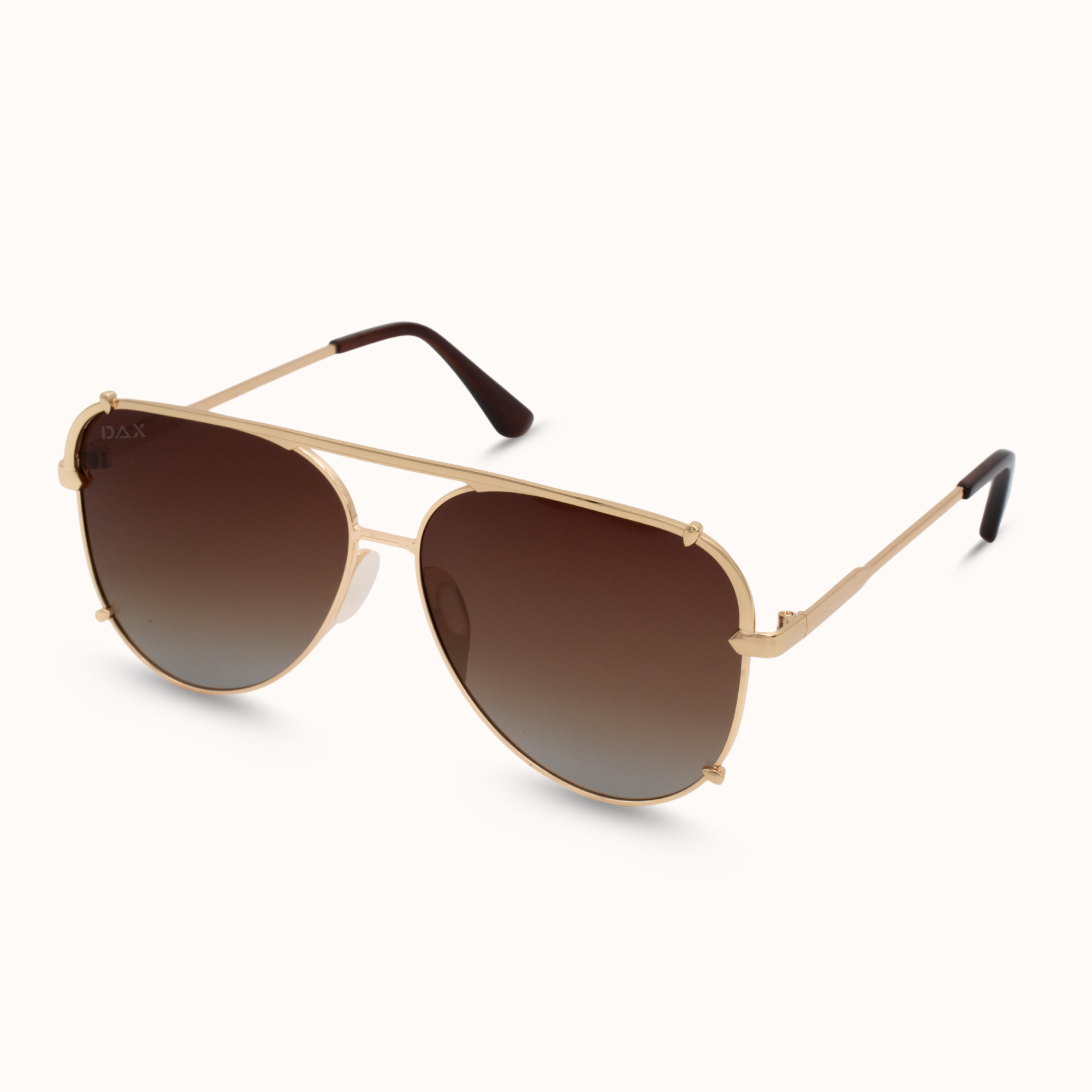 Gold-framed sunglasses with brown gradient lenses on a white background