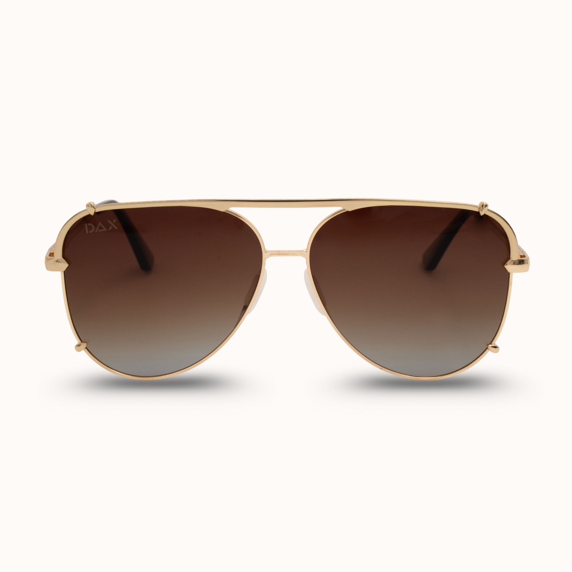 Gold-framed sunglasses with brown lenses on a white background