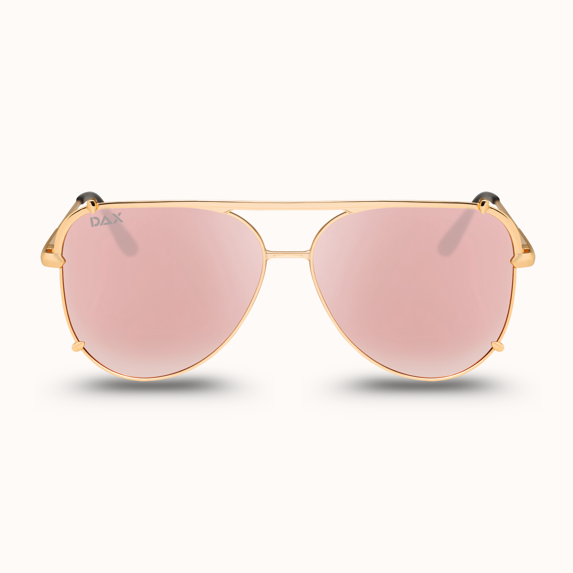 Gold-framed sunglasses with pink lenses on a white background