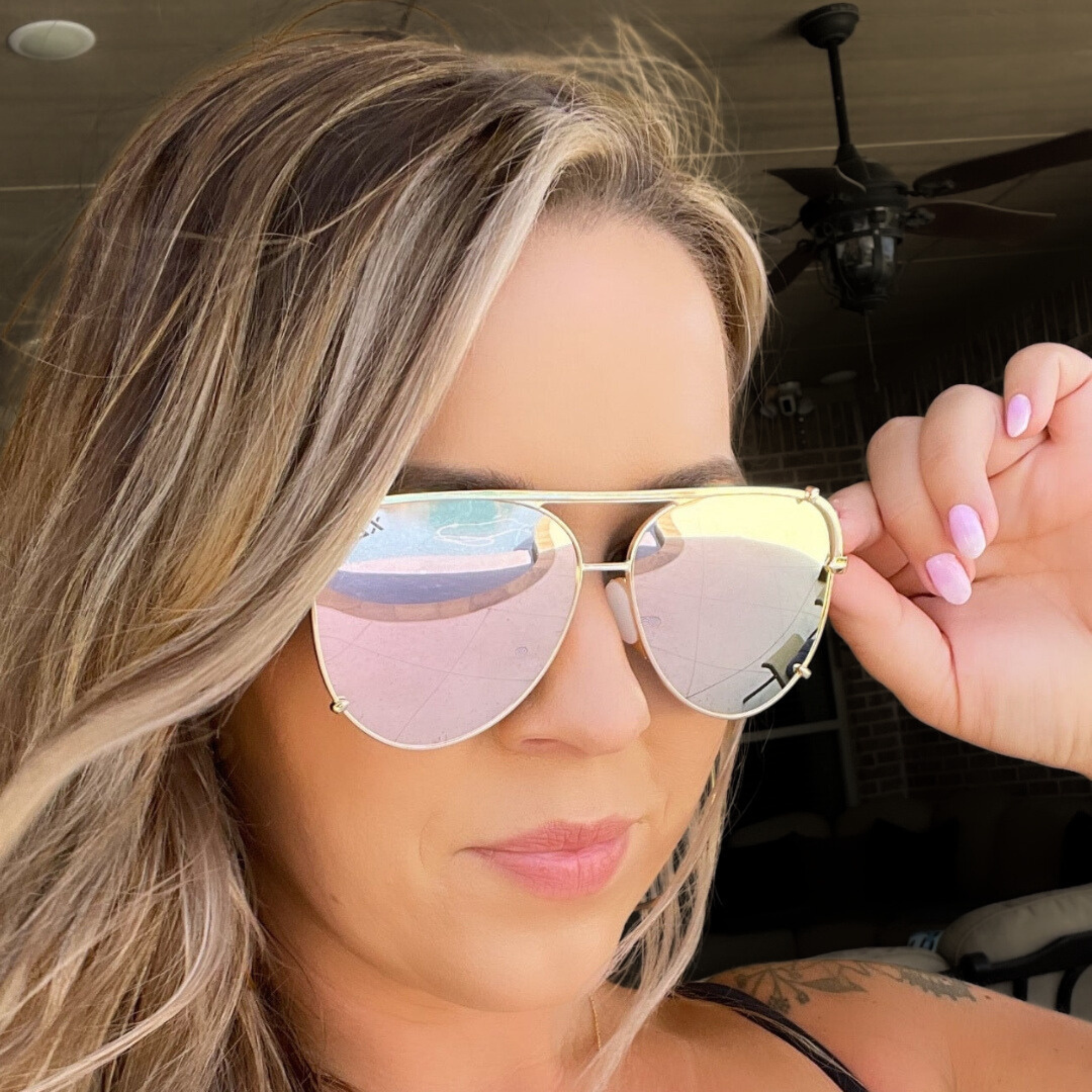 Woman wearing heart-shaped sunglasses with a blurred background