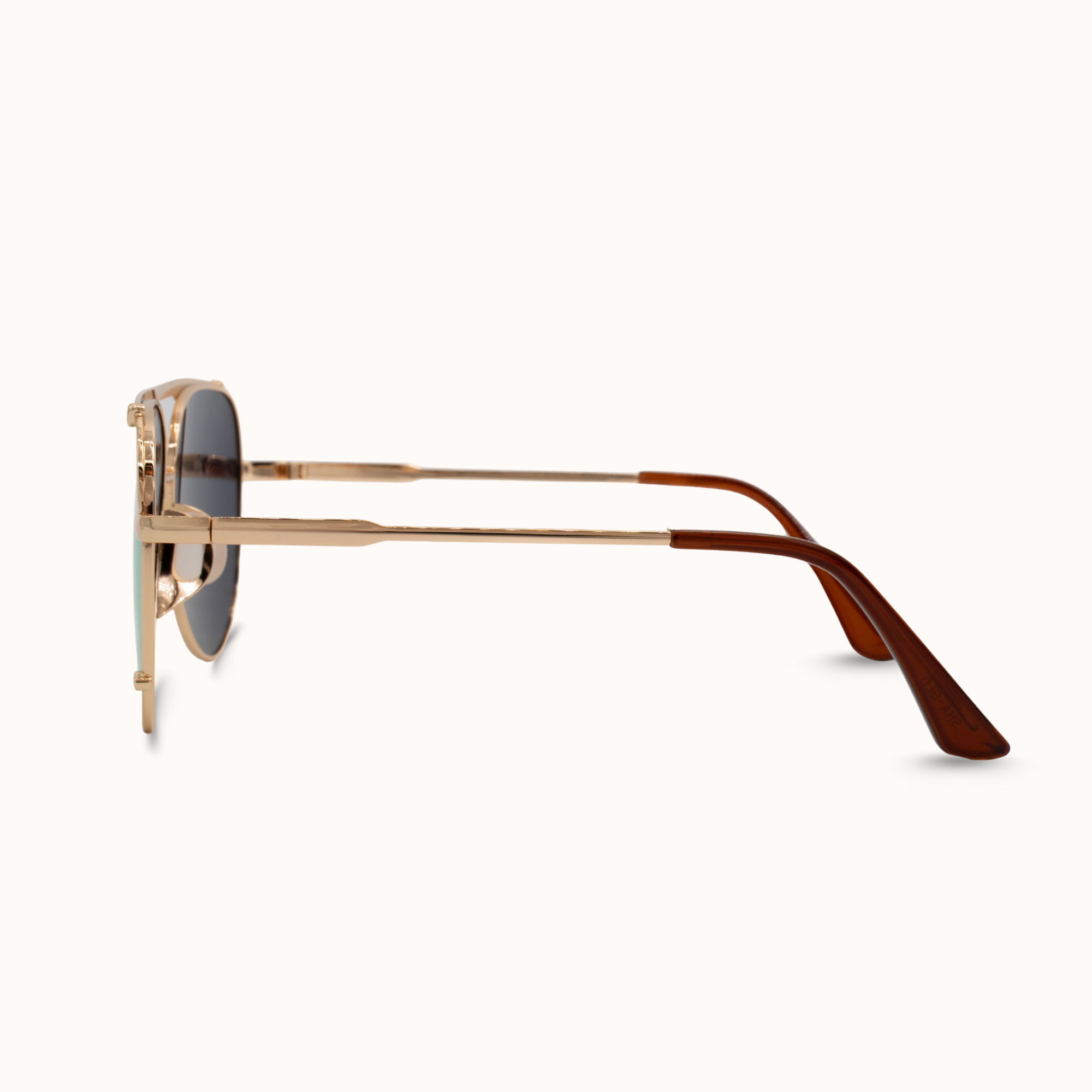Gold-framed sunglasses with brown arms on a white background