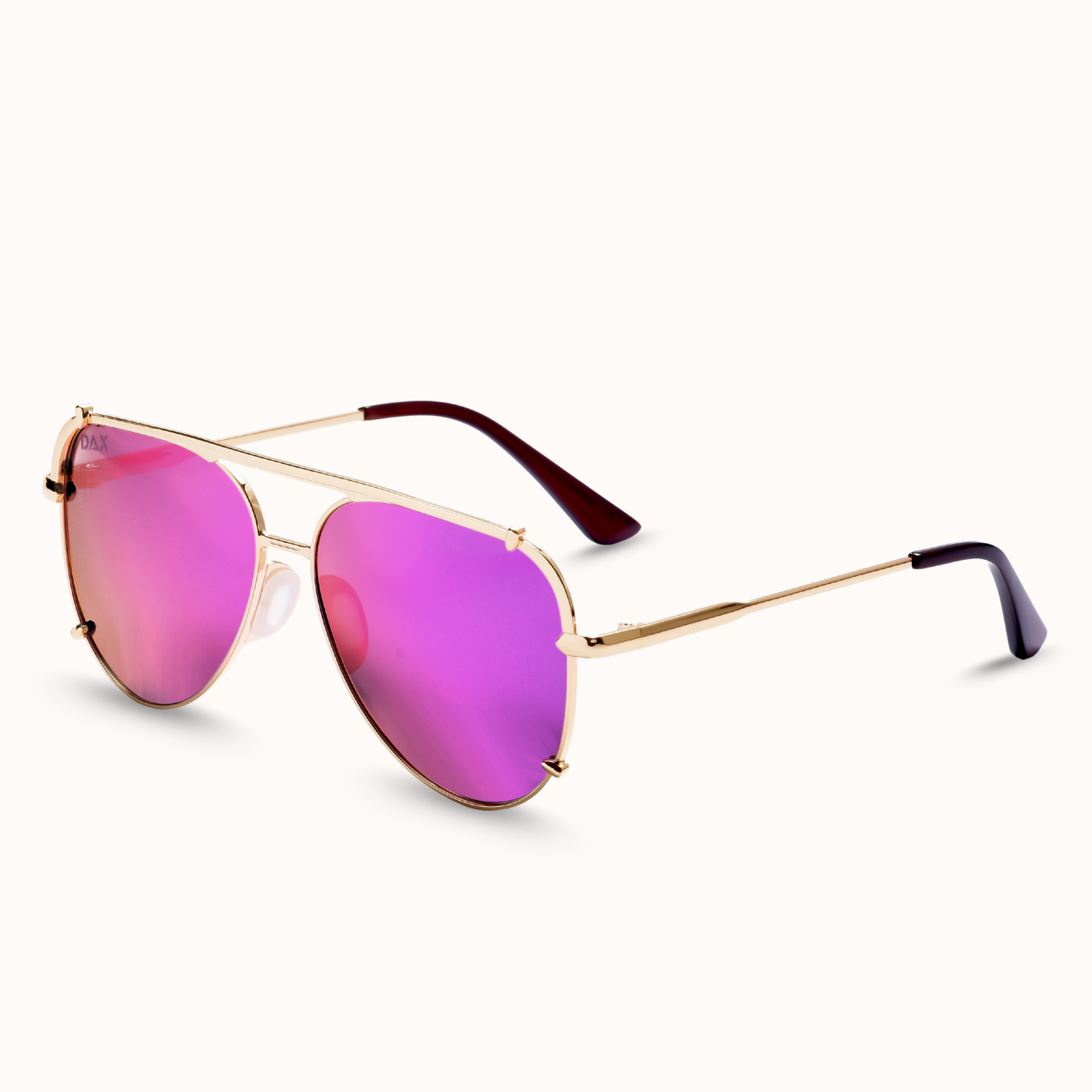 Sunglasses with pink lenses and gold frames on a white background