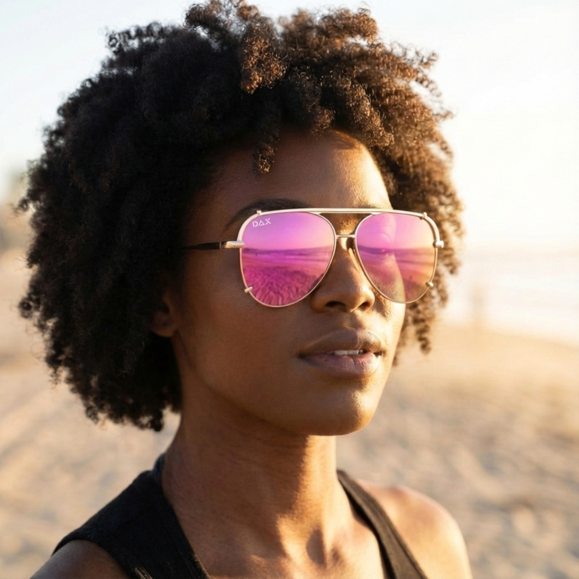 Woman wearing pink reflective sunglasses with a blurred natural background