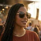 Woman wearing sunglasses with a blurred crowd in the background