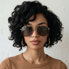Woman wearing sunglasses with a neutral background