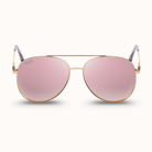 Aviator sunglasses with pink lenses and gold frames on a white background