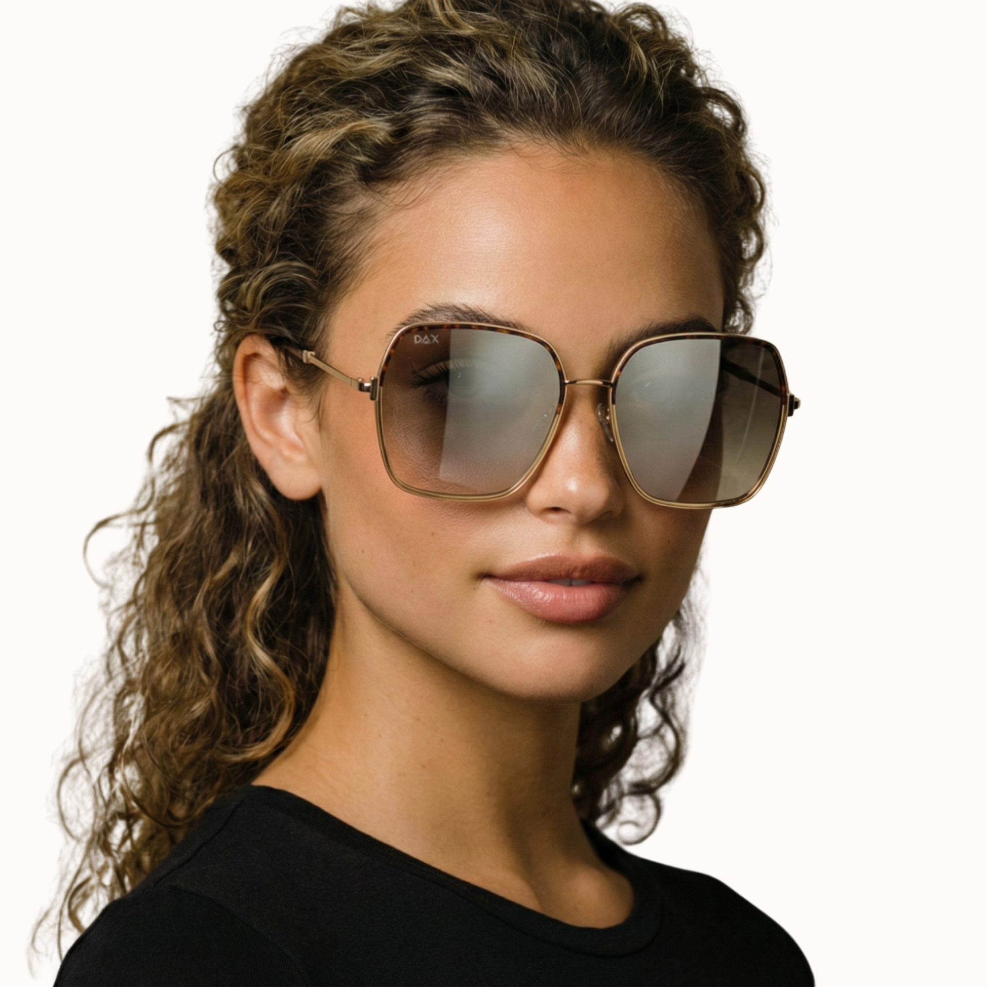 Woman wearing large sunglasses with a neutral background